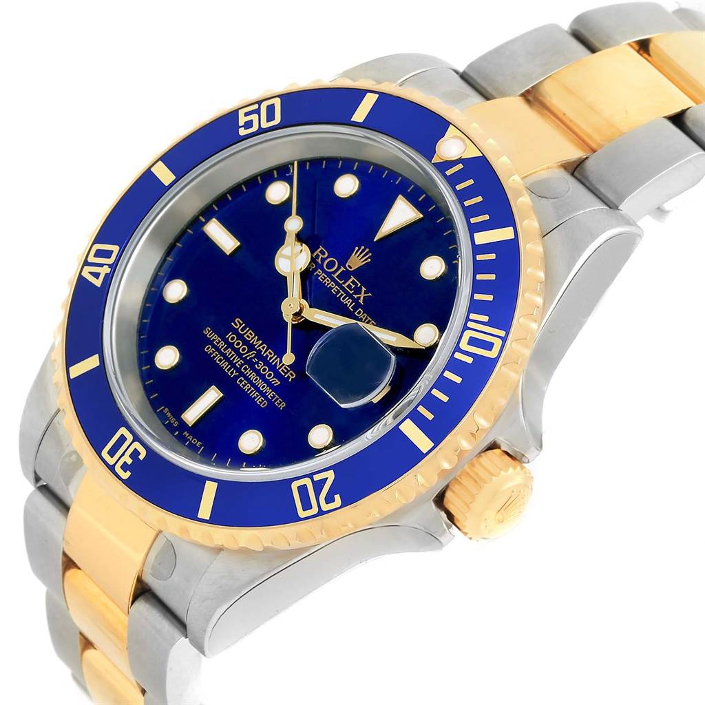 The image shows a Rolex Submariner 16613 Men's Steel and Gold (two tone) Blue Dial 16613 Men's Steel and Gold (two tone) Blue Dial watch with a blue and gold bezel, blue dial, and two-tone bracelet, angled from the front and right side.