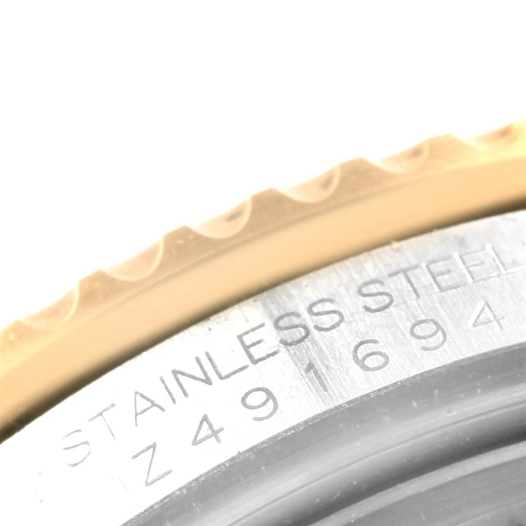 The image shows a close-up of the bezel and the engraved serial number on the side of a Rolex Submariner 16613 Men's Steel and Gold (two tone) Blue Dial 16613 Men's Steel and Gold (two tone) Blue Dial watch.