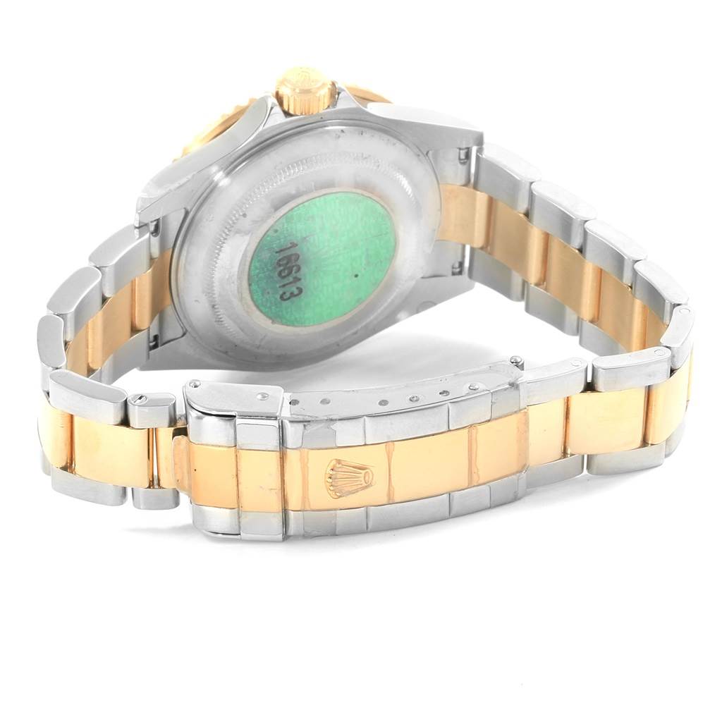 The image shows the back view of a Rolex Submariner 16613 Men's Steel and Gold (two tone) Blue Dial 16613 Men's Steel and Gold (two tone) Blue Dial, focusing on its bracelet and clasp, with a two-tone silver and gold finish.