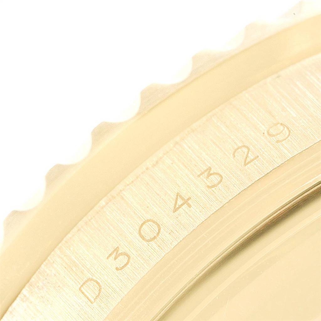 The image shows a close-up of the serial number engraving on the Rolex Submariner 16618 Men's Yellow Gold Black Dial 16618 Men's Yellow Gold Black Dial's inner bezel.