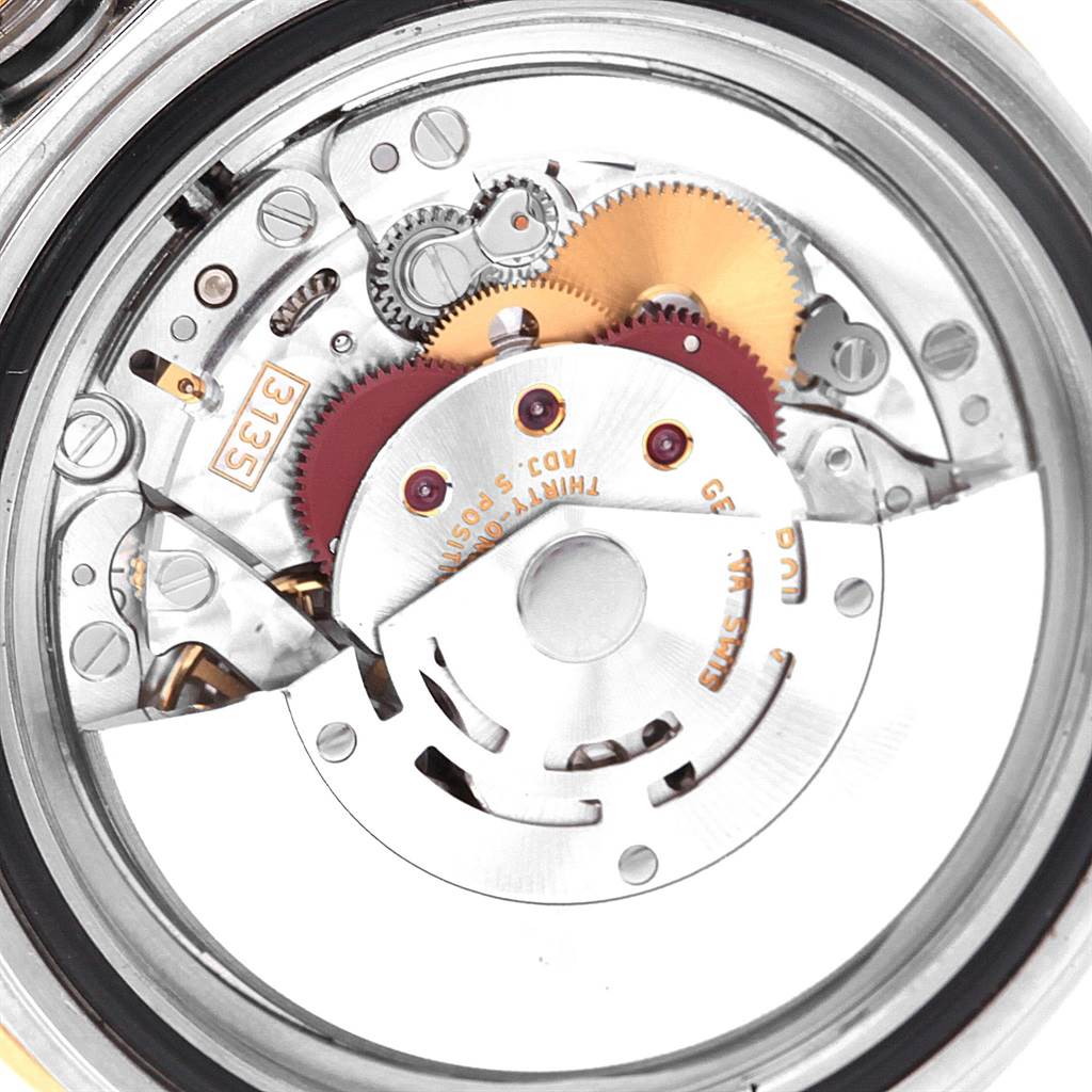 This image shows the internal mechanism and components of a Rolex Submariner 16613 Men's Steel and Gold (two tone) Grey Dial 16613 Men's Steel and Gold (two tone) Grey Dial watch from a close-up, rear view angle.