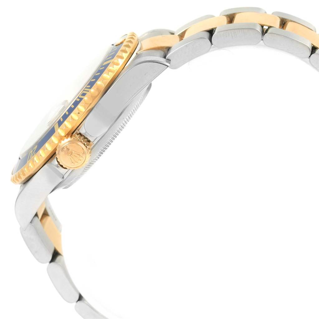 Side view of a Rolex Submariner 16613 Men's Steel and Gold (two tone) Grey Dial 16613 Men's Steel and Gold (two tone) Grey Dial showing the crown, bezel, and part of the bracelet.