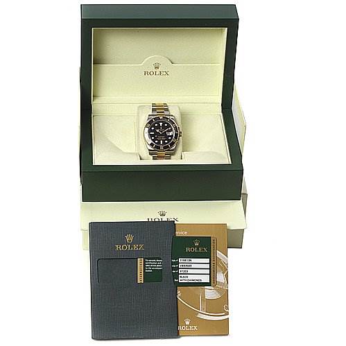 The image shows a Rolex Submariner 116613 Men's Yellow Gold Black Dial 116613 Men's Yellow Gold Black Dial watch in its open box, along with its warranty card and documentation.
