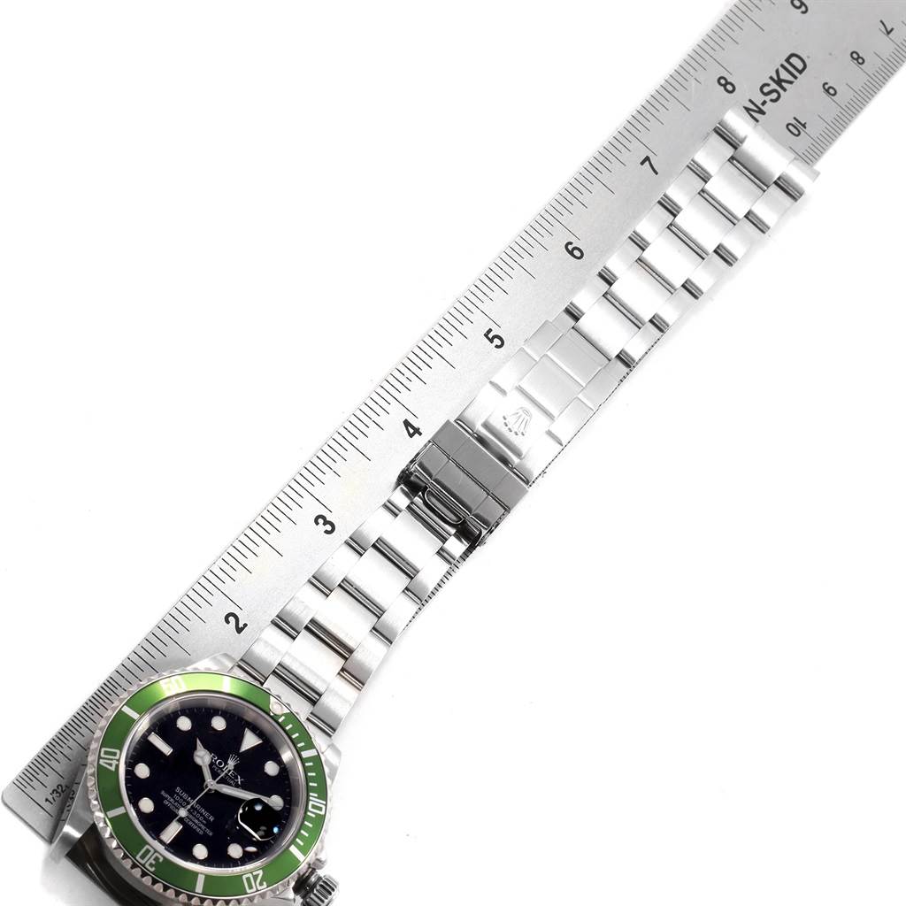 The image shows a top-down view of a Rolex Submariner 16610LV Men's Stainless Steel Black Dial 16610LV Men's Stainless Steel Black Dial watch, highlighting its green bezel, dial, and metal bracelet measured by a ruler.