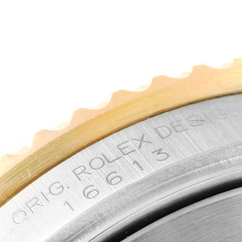 The image shows a close-up of the bezel and case edge of a Rolex Submariner 16613 Men's Steel and Gold (two tone) Blue Dial 16613 Men's Steel and Gold (two tone) Blue Dial, highlighting its model number and brand engraving.