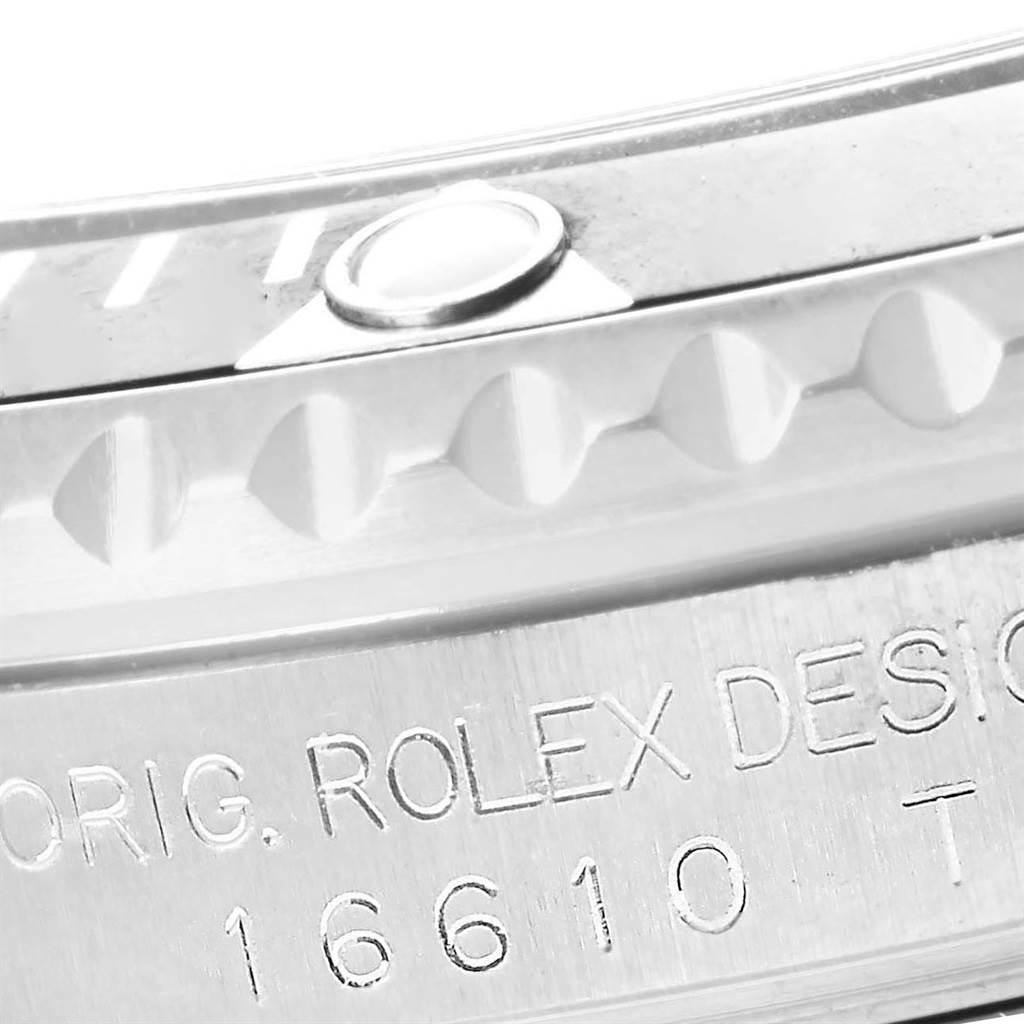 This close-up angle shows the bezel and case side of a Rolex Submariner 16610 Men
s Stainless Steel Black Dial 16610 Men
s Stainless Steel Black Dial model, including the engraved model number.