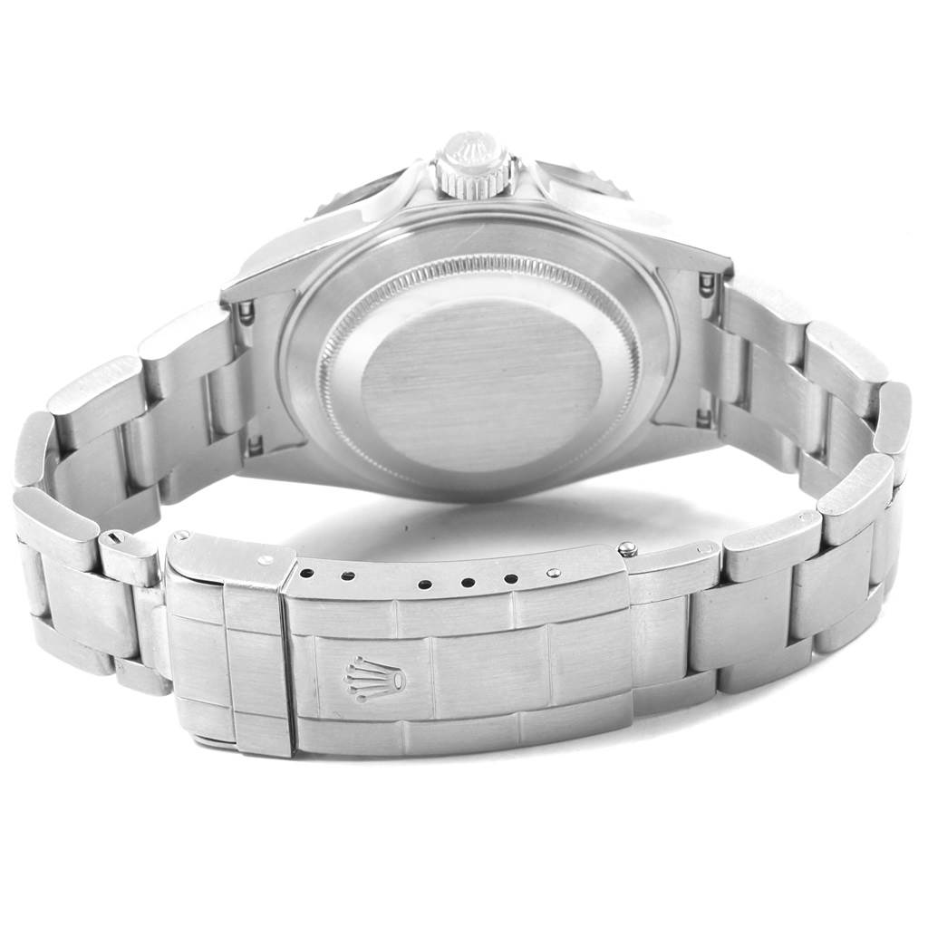 The image shows the back view of a Rolex Submariner 16610 Men
s Stainless Steel Black Dial 16610 Men
s Stainless Steel Black Dial watch, highlighting its case back and metal bracelet with a clasp.