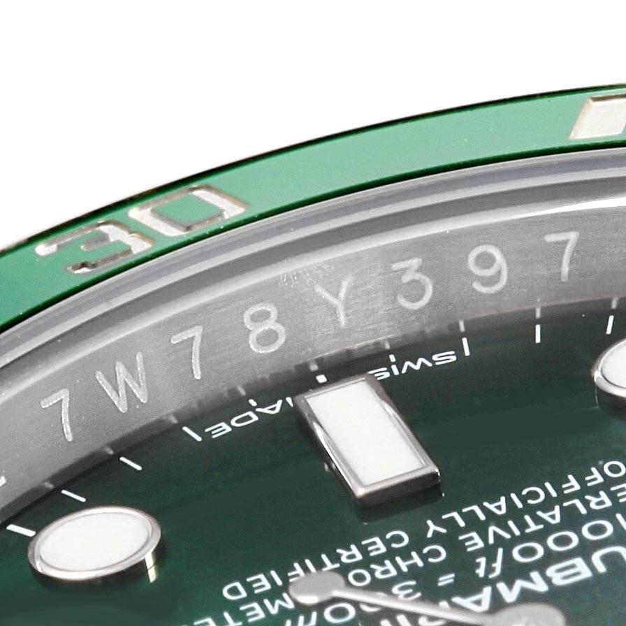 The image shows a close-up of the bezel and dial of a Rolex Submariner 116610LV Men
s Stainless Steel Green Dial 116610LV Men
s Stainless Steel Green Dial watch, highlighting the green bezel and luminescent markers.