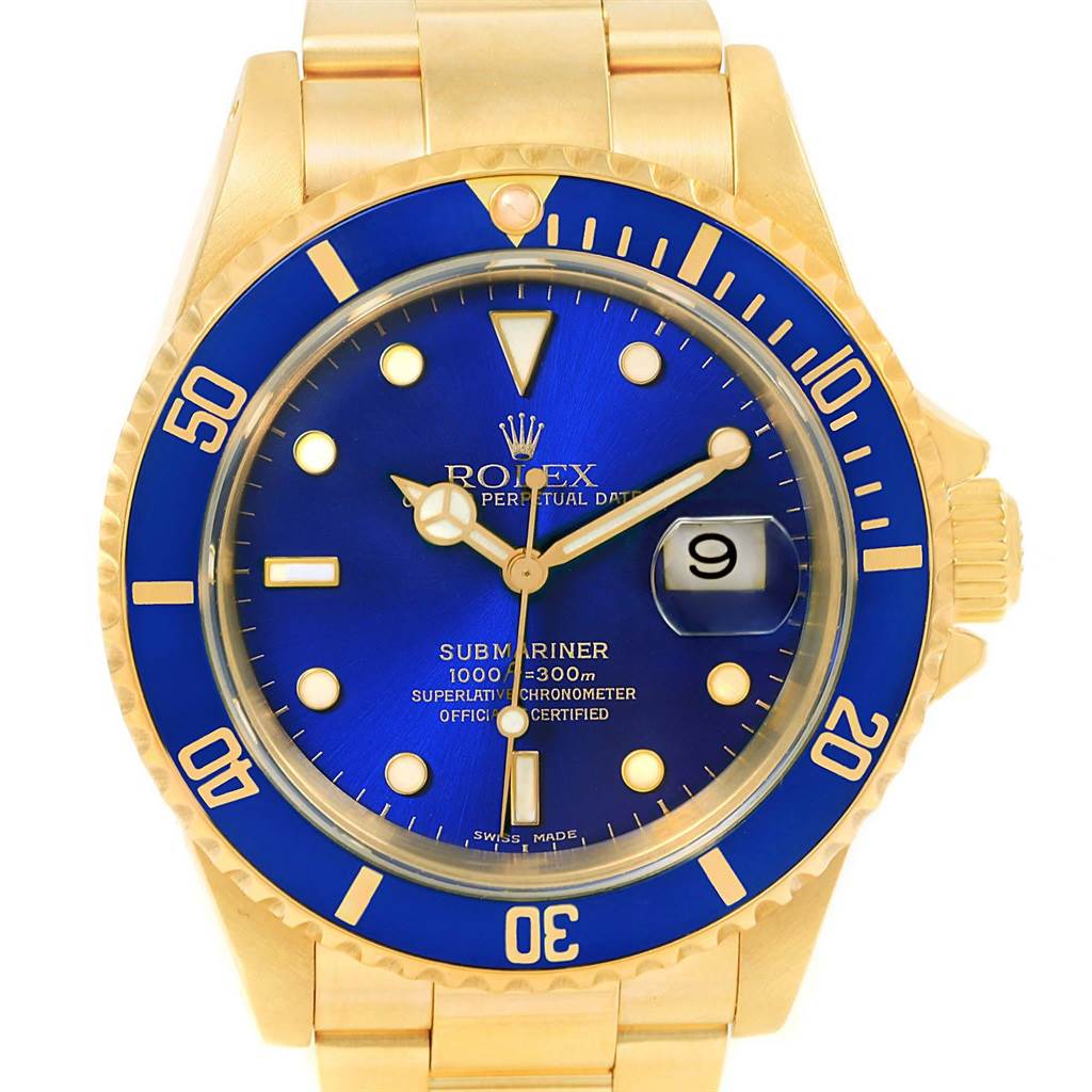 This Rolex Submariner 16618 Men's Yellow Gold Blue Dial 16618 Men's Yellow Gold Blue Dial watch is shown from the front, displaying the gold case, blue dial, date window, and part of the bracelet.