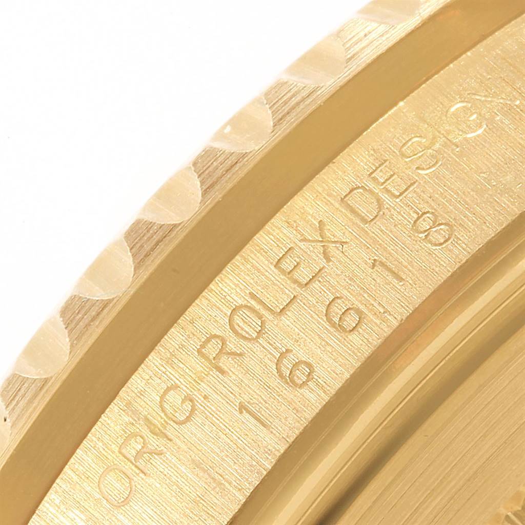 This image shows a close-up of the side view of the bezel and case of a Rolex Submariner 16618 Men's Yellow Gold Blue Dial 16618 Men's Yellow Gold Blue Dial watch, highlighting its engraving and material.