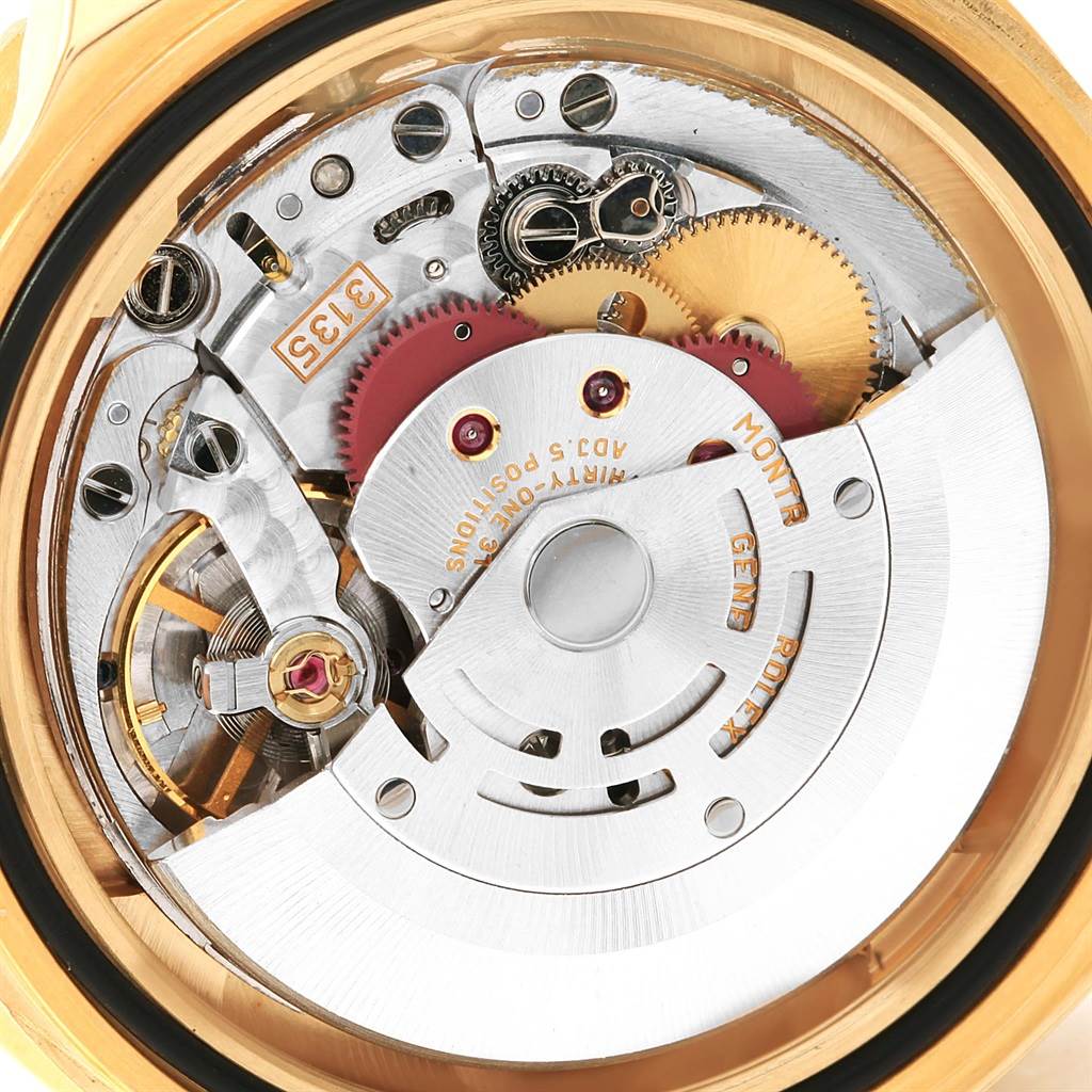 This is a close-up view of the internal mechanical movement of a Rolex Submariner 16618 Men's Yellow Gold Blue Dial 16618 Men's Yellow Gold Blue Dial watch, featuring gears and intricate parts.