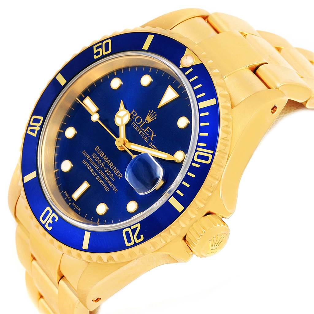 This image shows a close-up angled view of a gold Rolex Submariner 16618 Men's Yellow Gold Blue Dial 16618 Men's Yellow Gold Blue Dial watch, highlighting its blue dial, bezel, and crown.