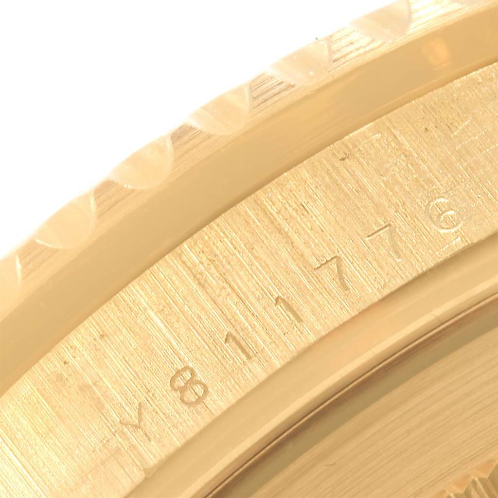 This close-up image shows a portion of the bezel and case back of a Rolex Submariner 16618 Men's Yellow Gold Blue Dial 16618 Men's Yellow Gold Blue Dial watch.