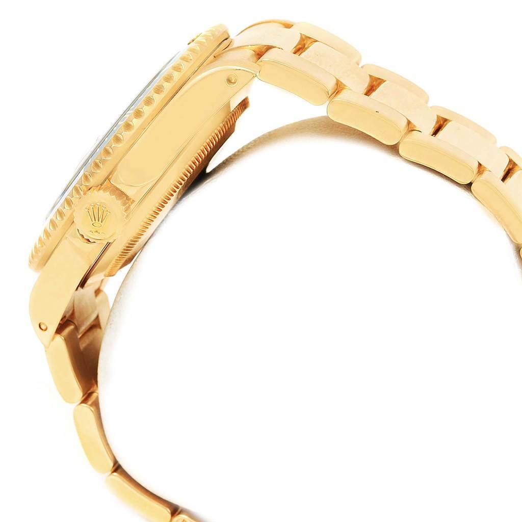 The image shows a side view of a Rolex Submariner 16618 Men's Yellow Gold Blue Dial 16618 Men's Yellow Gold Blue Dial watch, highlighting its gold case, bracelet, crown, and bezel.