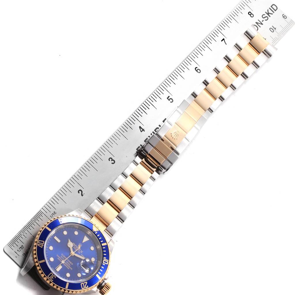 The image shows the face and bracelet of a Rolex Submariner 16613 Men's Steel and Gold (two tone) Blue Dial 16613 Men's Steel and Gold (two tone) Blue Dial watch, measured with a ruler.