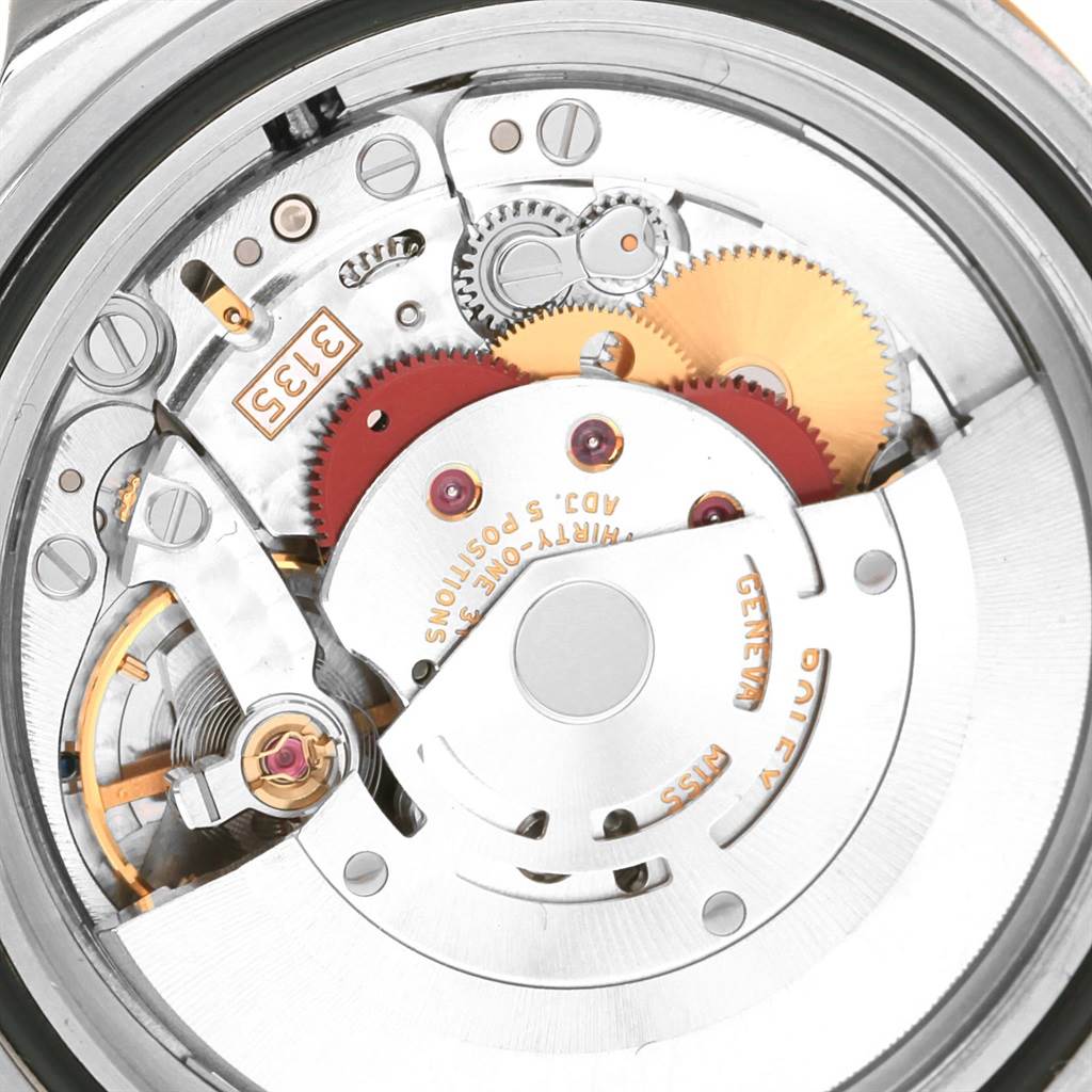 This image shows a close-up view of the internal mechanical movement of a Rolex Submariner 16613 Men's Steel and Gold (two tone) Blue Dial 16613 Men's Steel and Gold (two tone) Blue Dial watch.