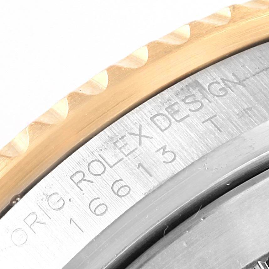 The image shows a close-up of the bezel and engraved case details on a Rolex Submariner 16613 Men's Steel and Gold (two tone) Black Dial 16613 Men's Steel and Gold (two tone) Black Dial watch.