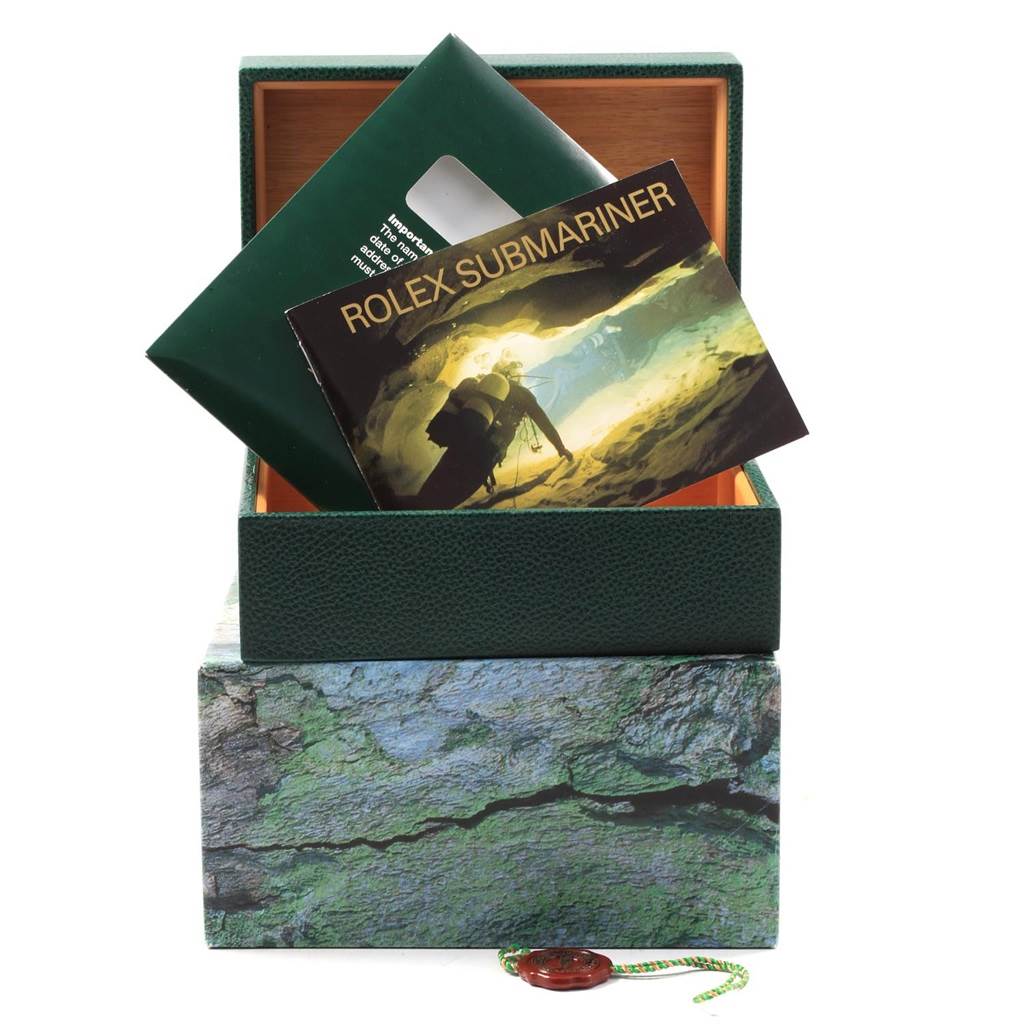 The image shows a Rolex Submariner 16613 Men's Steel and Gold (two tone) Black Dial 16613 Men's Steel and Gold (two tone) Black Dial watch box, opened, with a booklet and documents inside.