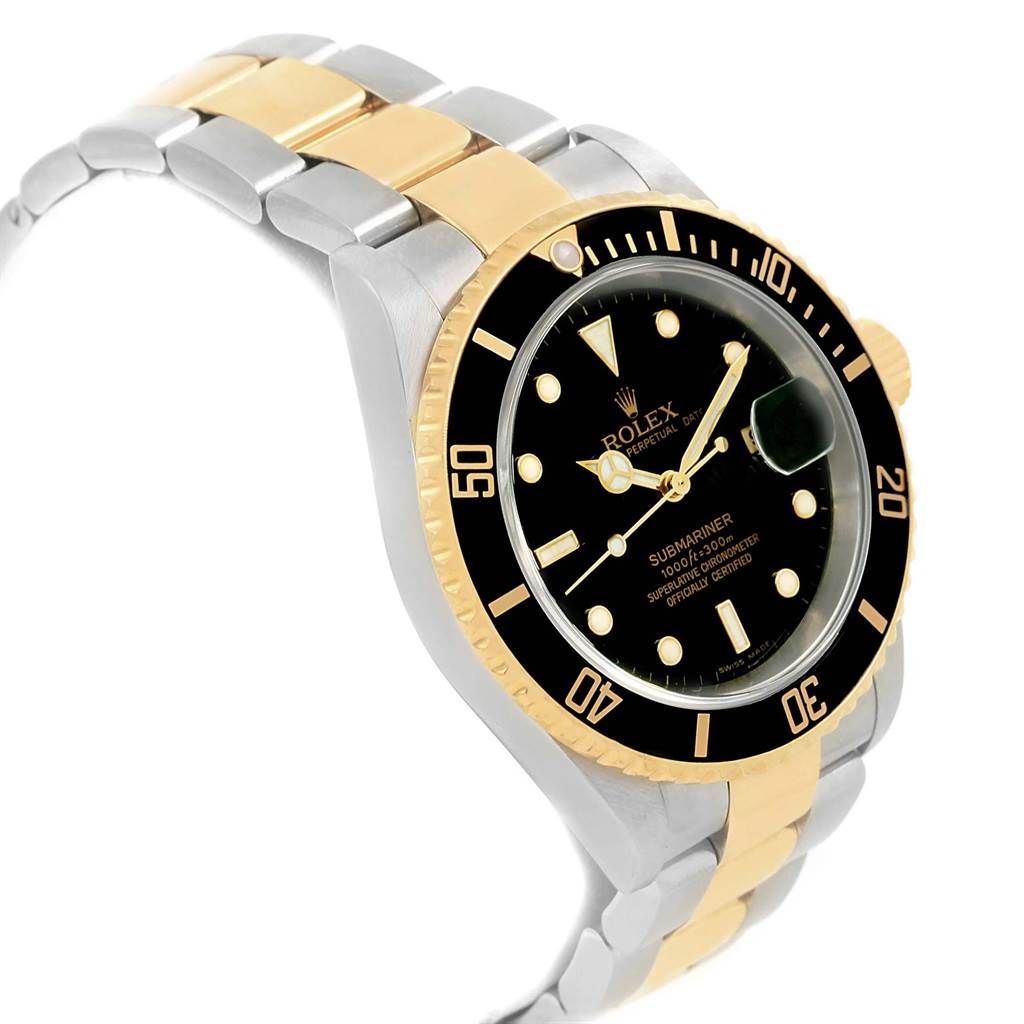 This is a tilted side view of a Rolex Submariner 16613 Men's Steel and Gold (two tone) Black Dial 16613 Men's Steel and Gold (two tone) Black Dial showing its black dial, gold bezel, two-tone bracelet, and luminescent markers.
