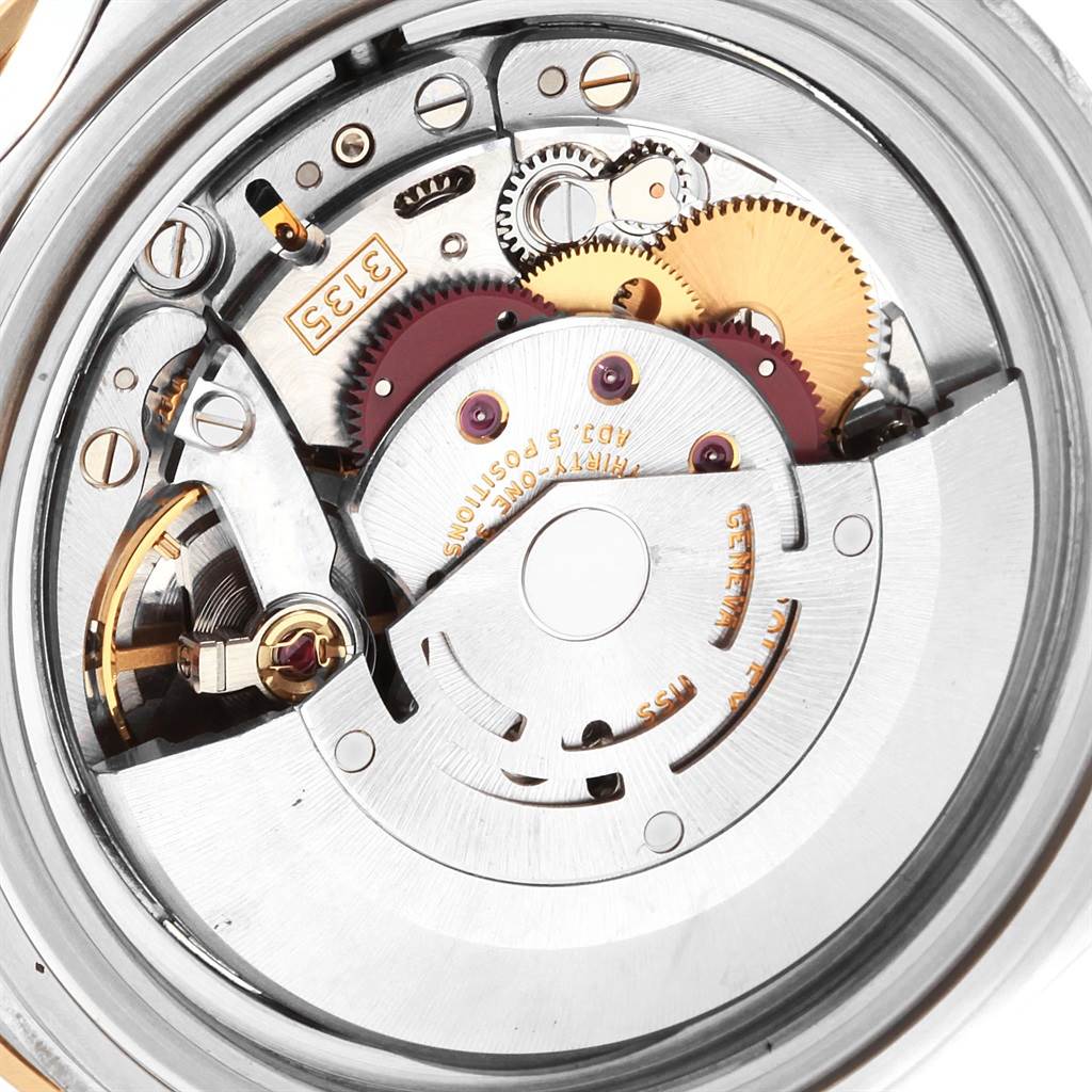 This image shows the detailed inner mechanism, including gears and components, of a Rolex Submariner 16613 Men's Steel and Gold (two tone) Blue Dial 16613 Men's Steel and Gold (two tone) Blue Dial watch.