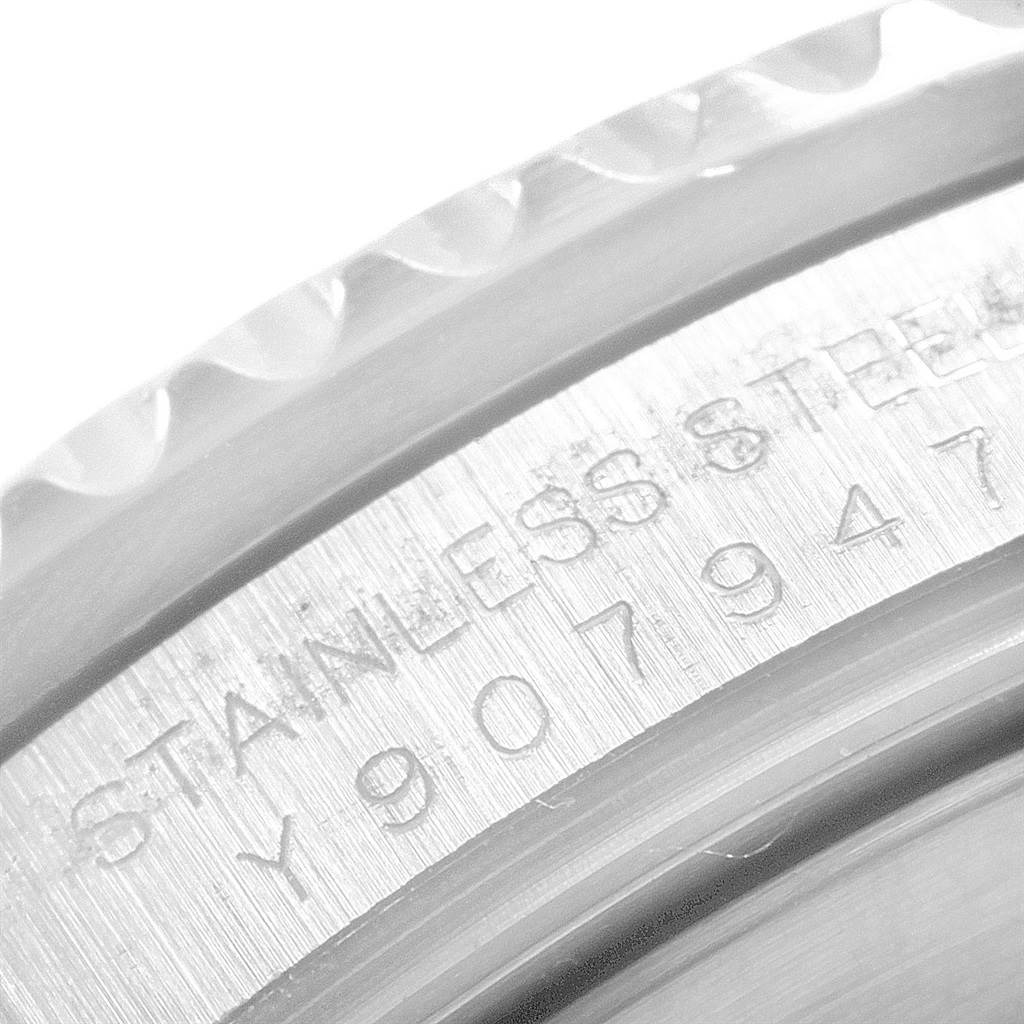 This close-up image shows the engraved stainless steel casing of a Rolex Submariner 16610 Men's Stainless Steel Black Dial 16610 Men's Stainless Steel Black Dial watch at an angled perspective.