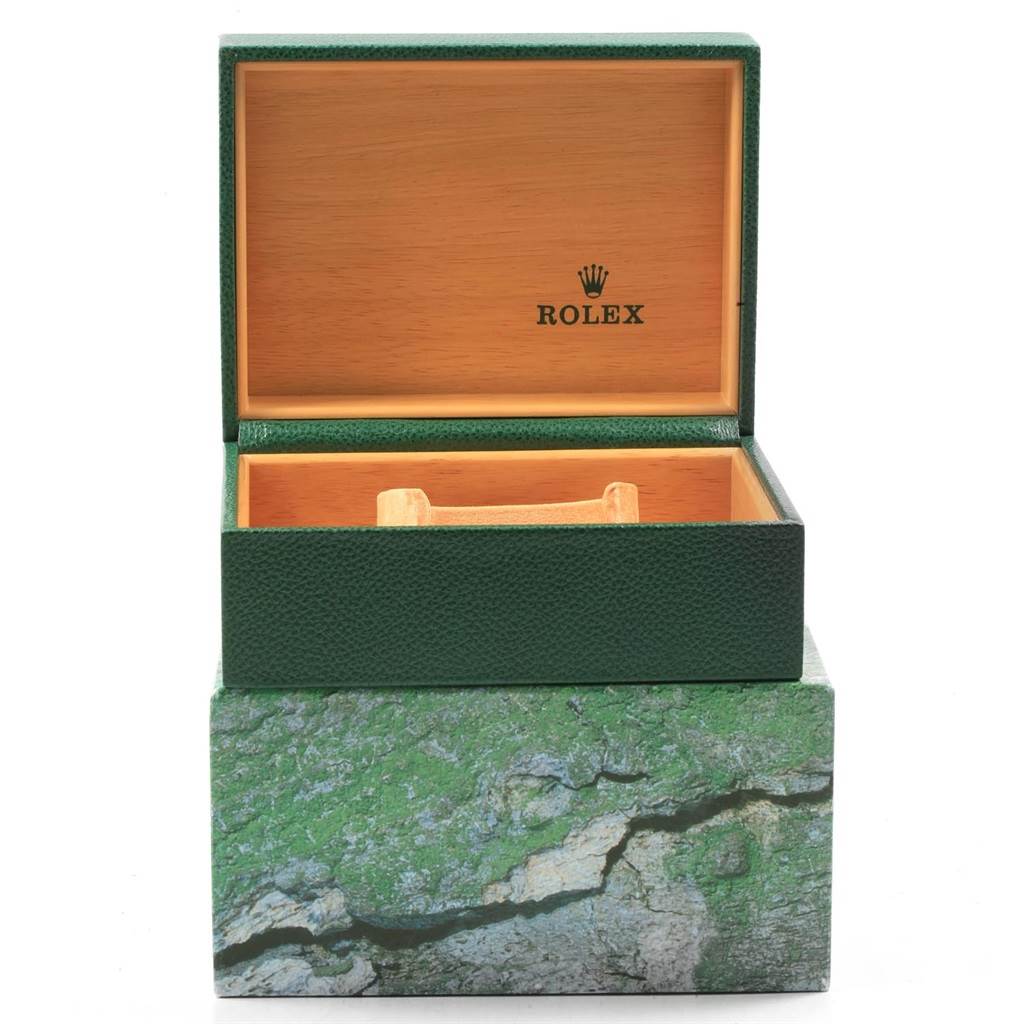 This image shows an open green Rolex Submariner 16610 Men's Stainless Steel Black Dial 16610 Men's Stainless Steel Black Dial watch box, revealing the wooden interior and Rolex logo on the lid.