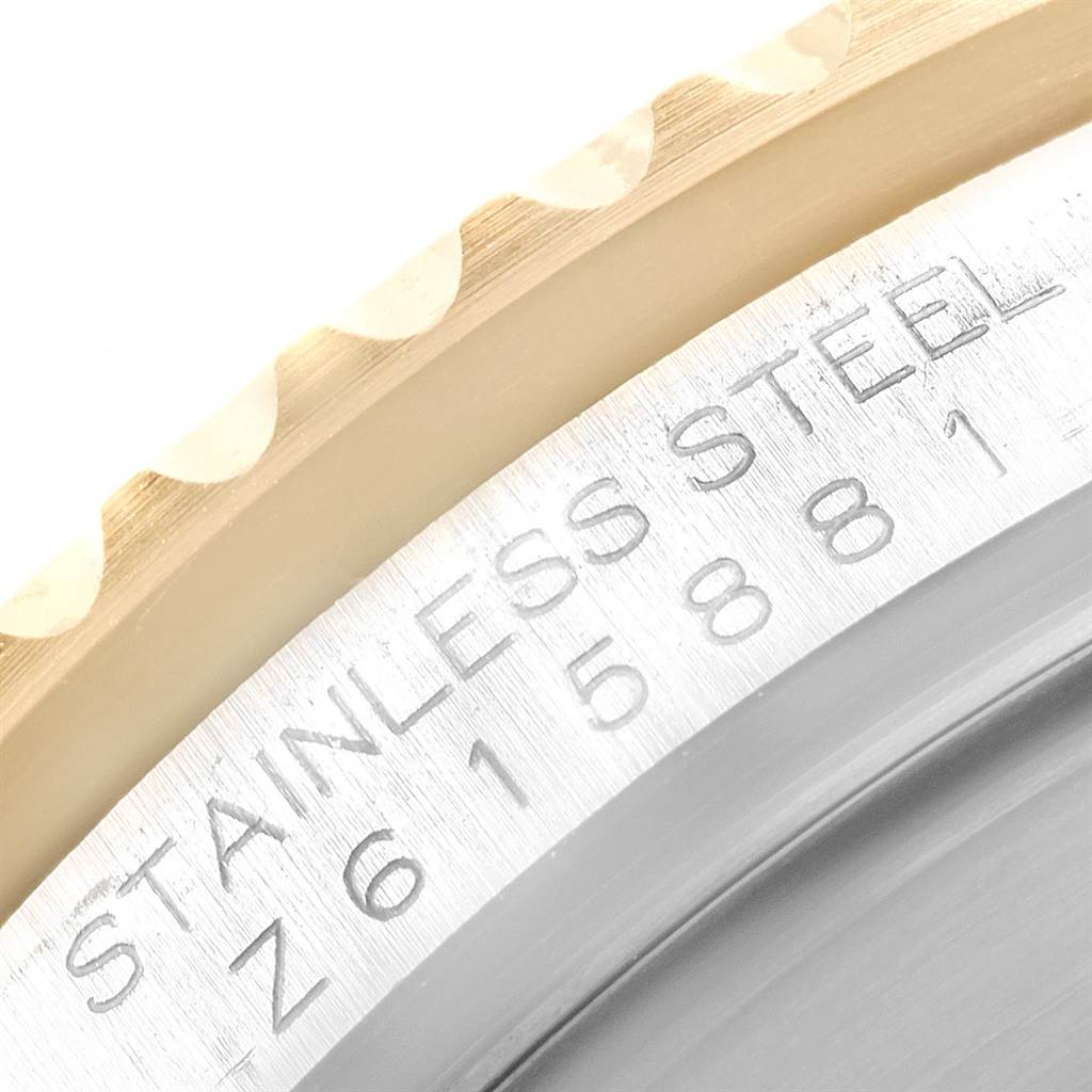 This zoomed-in view shows part of the bezel and case, including the engraved serial number, of the Rolex Submariner 16613 Men's Steel and Gold (two tone) Blue Dial 16613 Men's Steel and Gold (two tone) Blue Dial watch.