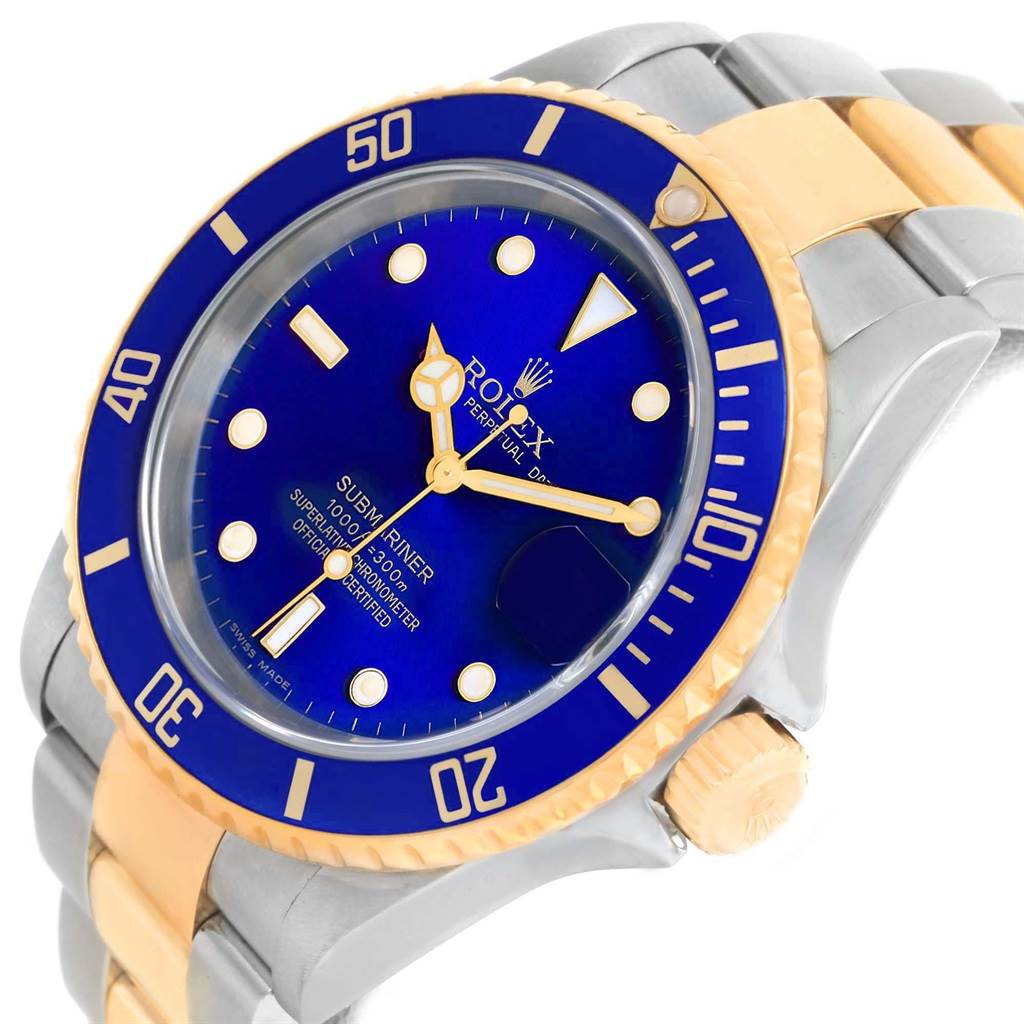 The image shows a close-up angle of a Rolex Submariner 16613 Men's Steel and Gold (two tone) Blue Dial 16613 Men's Steel and Gold (two tone) Blue Dial watch, highlighting its blue dial, bezel, and two-tone bracelet.