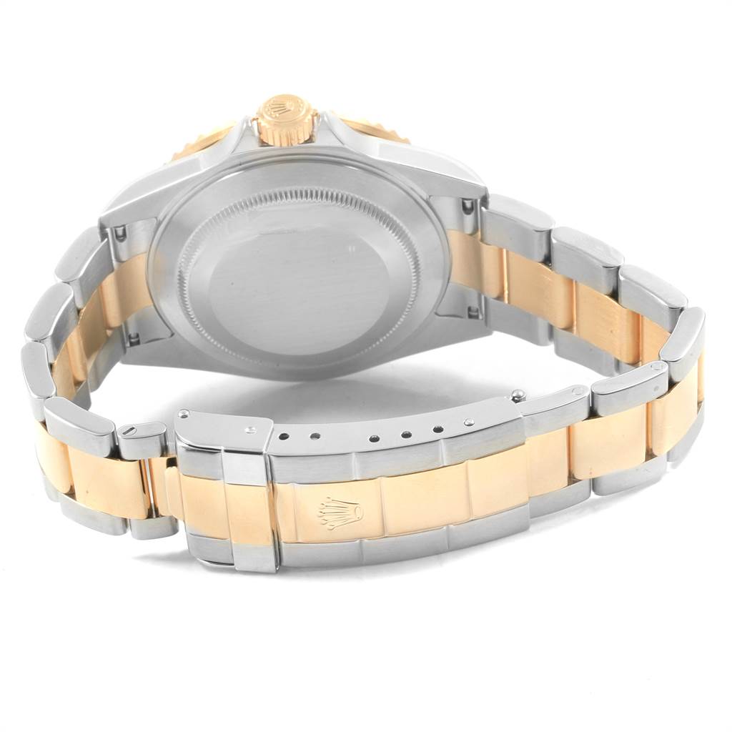 The image shows the back side of a Rolex Submariner 16613 Men's Steel and Gold (two tone) Black Dial 16613 Men's Steel and Gold (two tone) Black Dial, highlighting the case back and two-tone bracelet with the clasp.