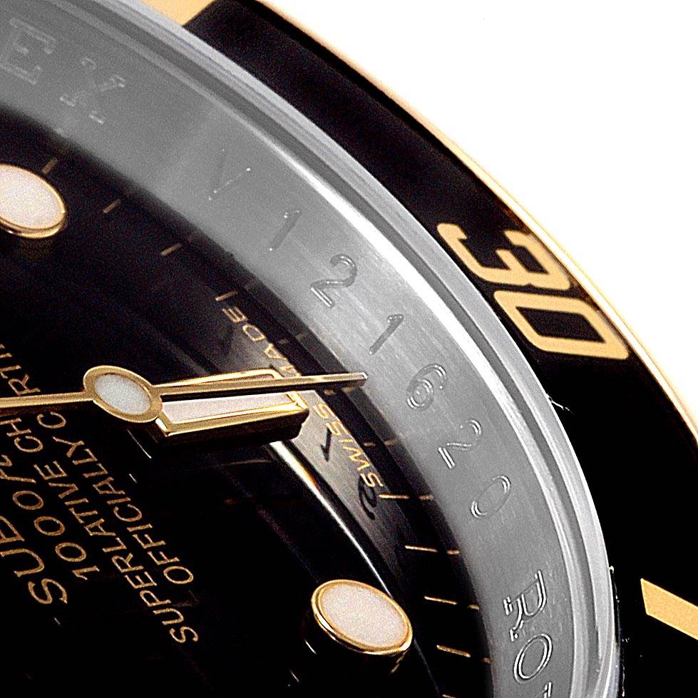 This image shows a close-up of the bezel and dial of the Rolex Submariner 16613 Men's Steel and Gold (two tone) Black Dial 16613 Men's Steel and Gold (two tone) Black Dial watch, focusing on the hands and part of the indices.