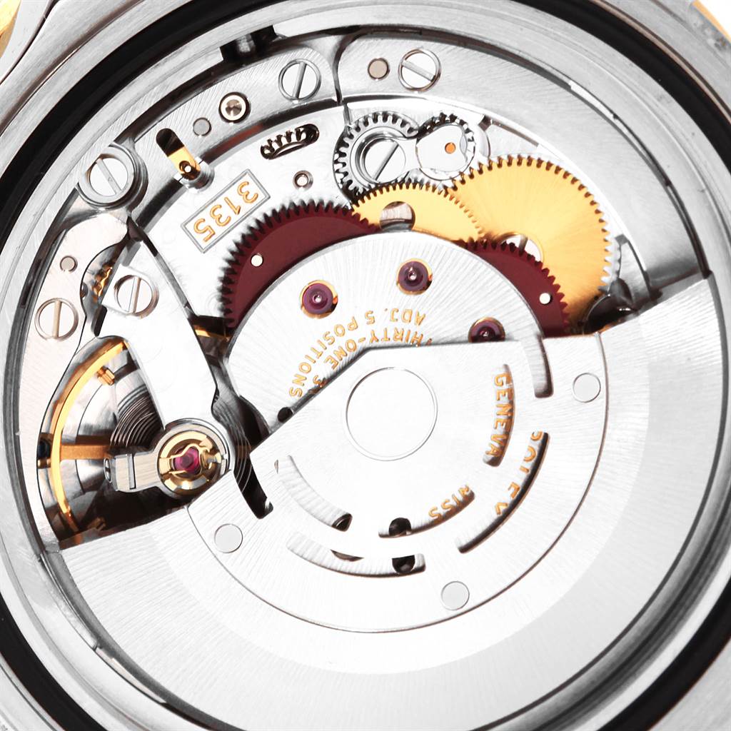 The image shows the inner mechanical movement of a Rolex Submariner 16613 Men's Steel and Gold (two tone) Black Dial 16613 Men's Steel and Gold (two tone) Black Dial watch, showcasing gears and moving parts from a close-up angle.