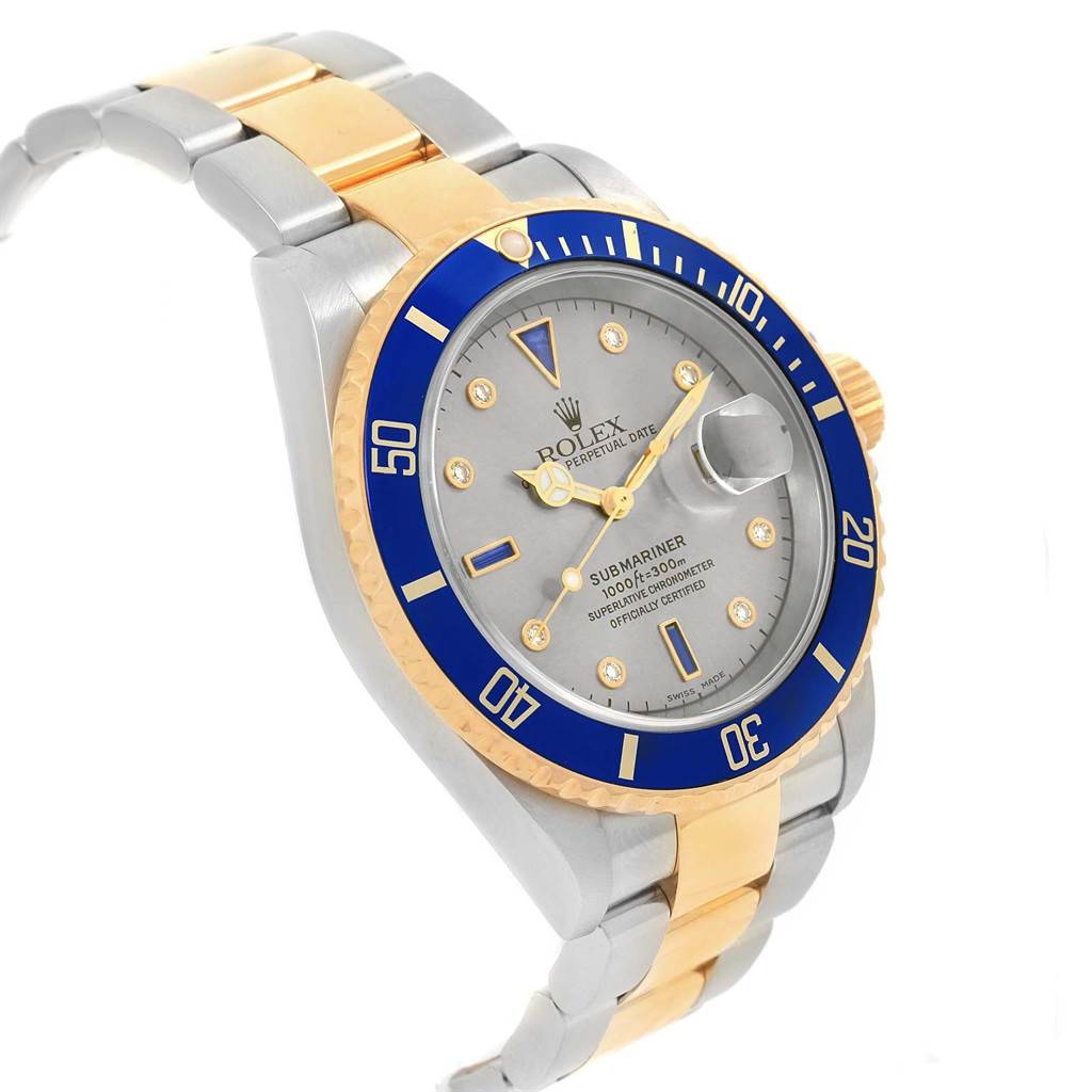 This image shows a Rolex Submariner 16613 Men's Steel and Gold (two tone) Grey Dial 16613 Men's Steel and Gold (two tone) Grey Dial watch at a slight angle, highlighting the bezel, dial, and two-tone metal bracelet.