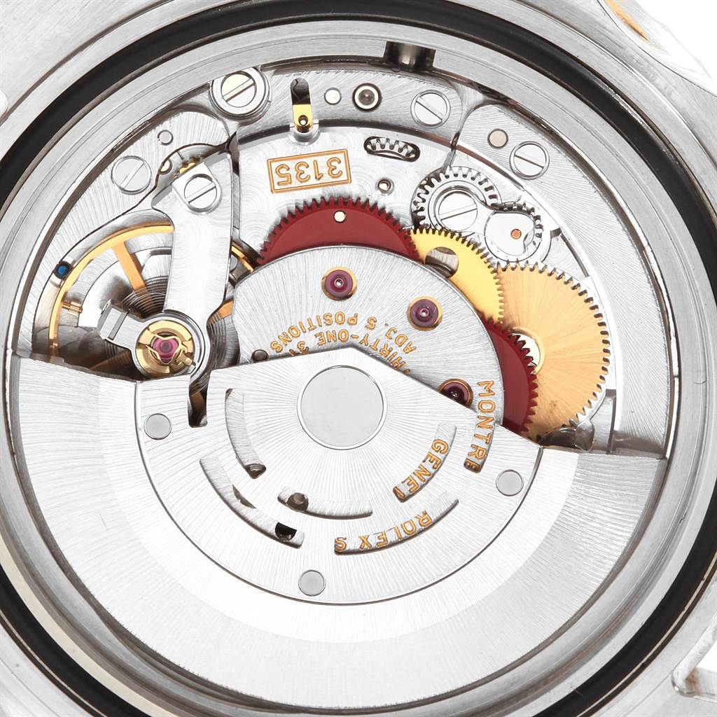 This close-up image shows the intricate inner movement mechanism of a Rolex Submariner 16613 Men's Steel and Gold (two tone) Grey Dial 16613 Men's Steel and Gold (two tone) Grey Dial watch.