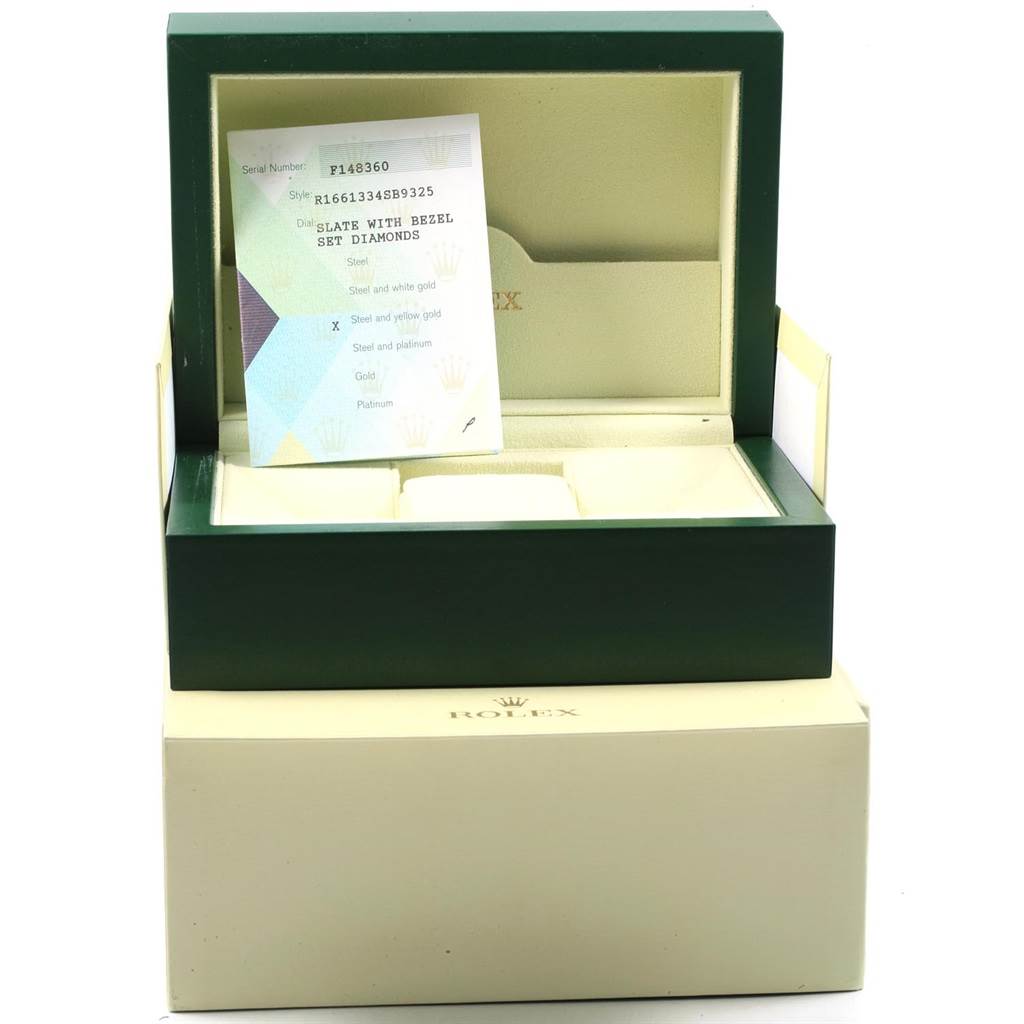 Angle shows an opened Rolex Submariner 16613 Men's Steel and Gold (two tone) Grey Dial 16613 Men's Steel and Gold (two tone) Grey Dial box with documentation inside.