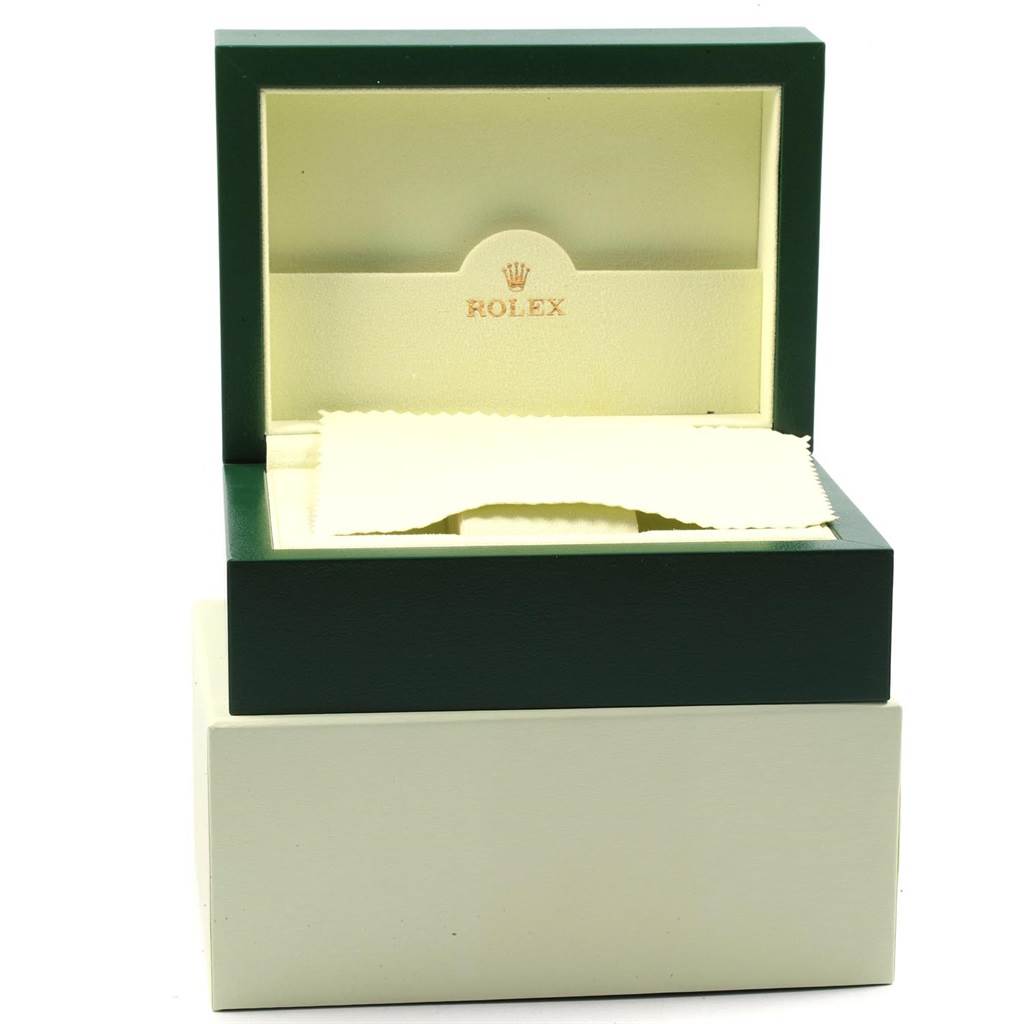 This image shows an open green and beige Rolex watch box for the Submariner model, displaying the interior with a cloth.