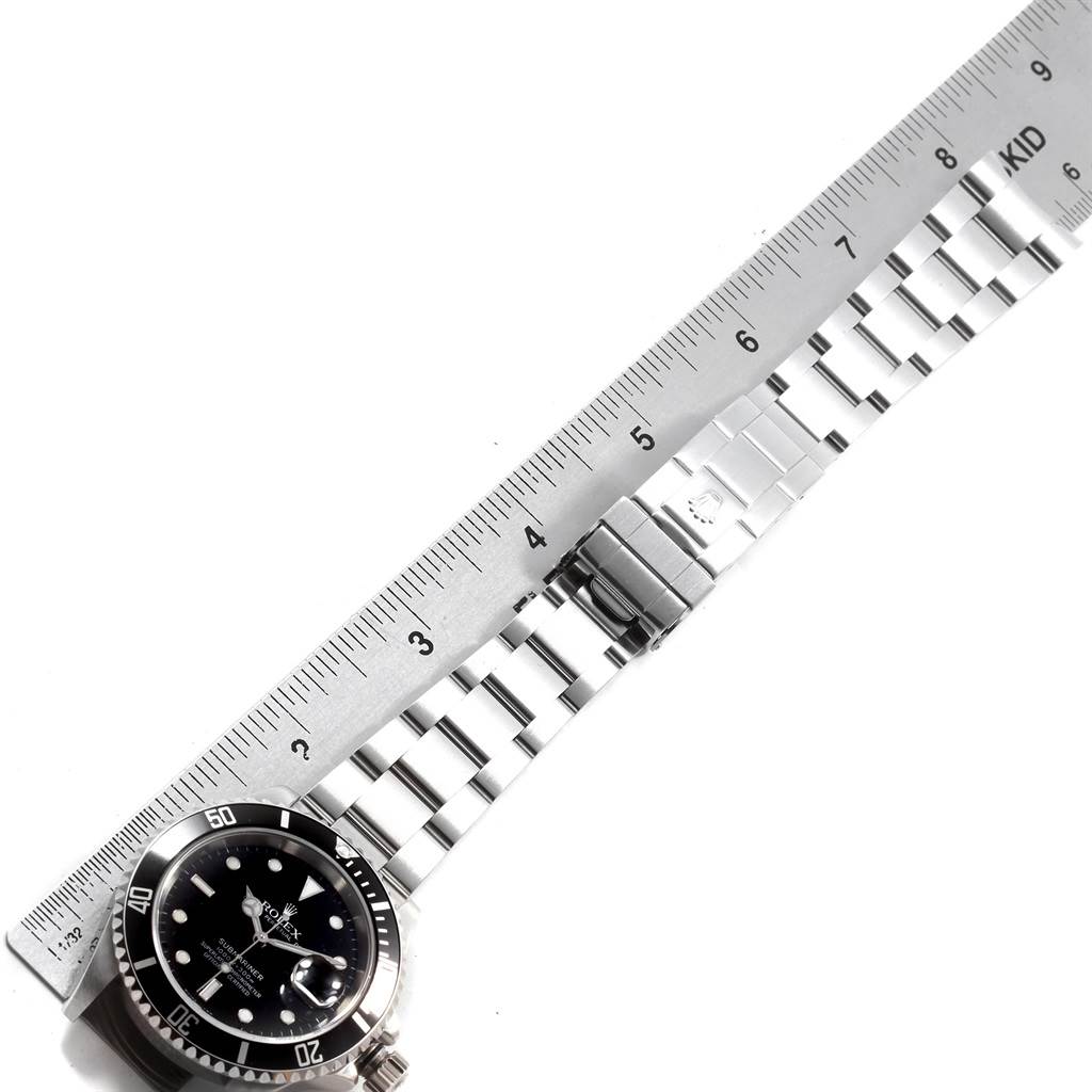 The image shows a Rolex Submariner 16610 Men's Stainless Steel Black Dial 16610 Men's Stainless Steel Black Dial watch laid flat with its bracelet extended, measured against a ruler.
