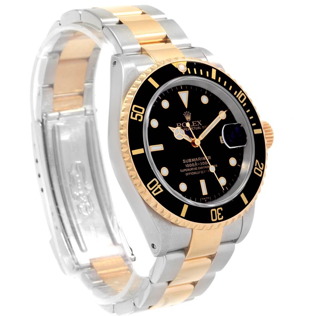 The Rolex Submariner 16613 Men's Steel and Gold (two tone) Black Dial 16613 Men's Steel and Gold (two tone) Black Dial watch is shown at an oblique angle, highlighting its black dial, bezel, and two-tone bracelet.