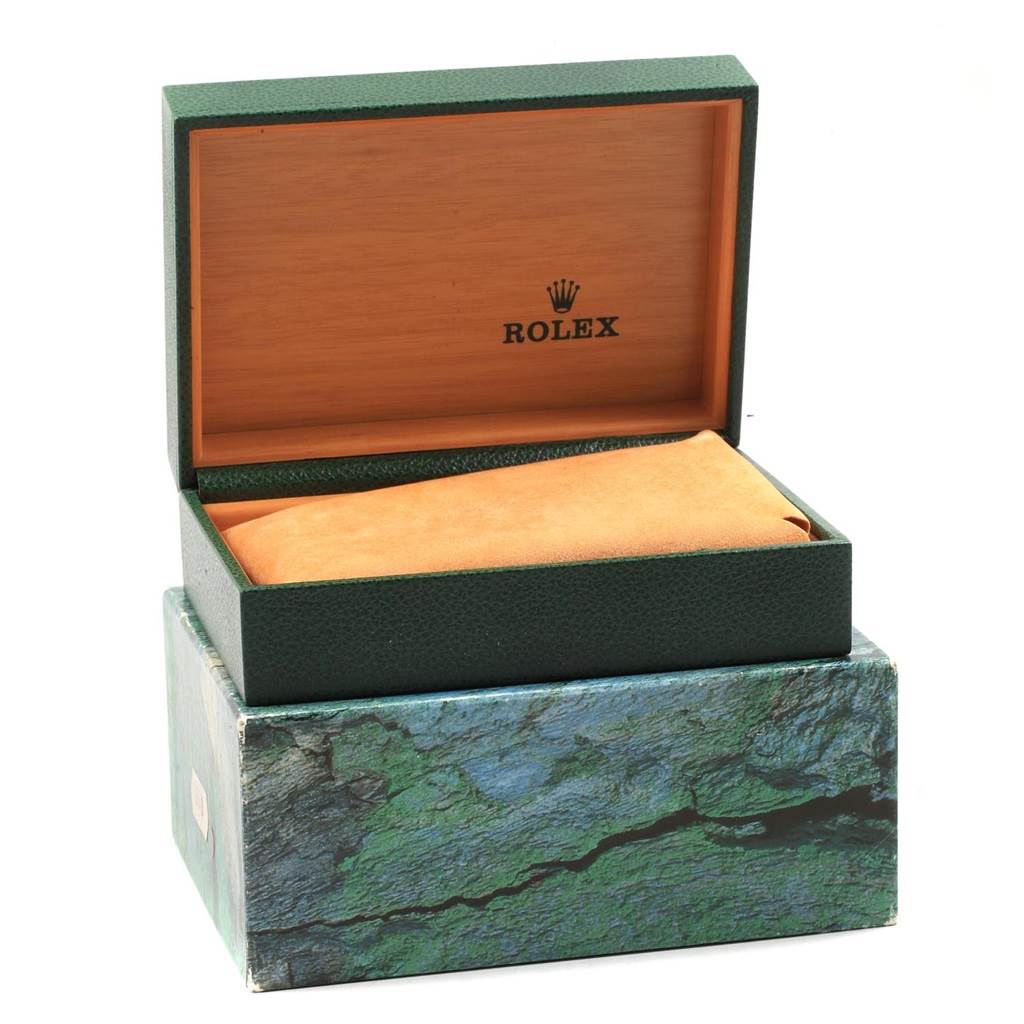 This image shows the open box of a Rolex Submariner 16613 Men's Steel and Gold (two tone) Black Dial 16613 Men's Steel and Gold (two tone) Black Dial watch, revealing the interior with a suede cushion.