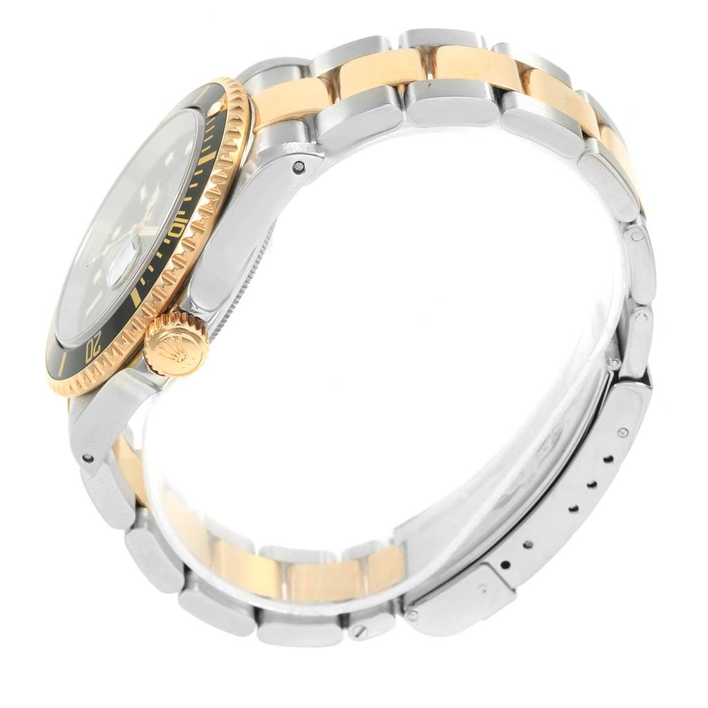 The image shows a side view of a Rolex Submariner 16613 Men's Steel and Gold (two tone) Black Dial 16613 Men's Steel and Gold (two tone) Black Dial watch, focusing on the bezel, crown, and two-tone metal bracelet.