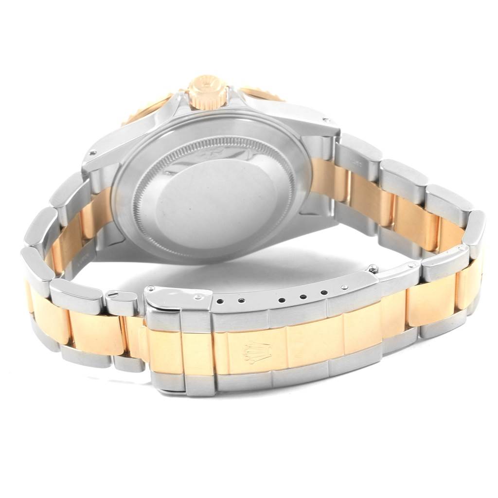 The image shows the back and clasp of a Rolex Submariner 16613 Men's Steel and Gold (two tone) Black Dial 16613 Men's Steel and Gold (two tone) Black Dial watch, highlighting its two-tone metal bracelet.