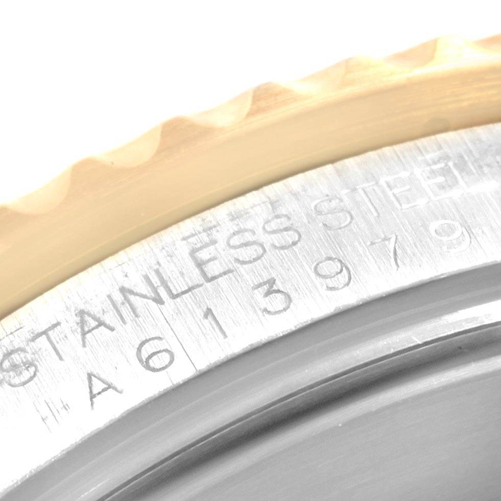 This image shows a close-up of the case back edge and part of the bezel of a Rolex Submariner 16613 Men's Steel and Gold (two tone) Black Dial 16613 Men's Steel and Gold (two tone) Black Dial watch.