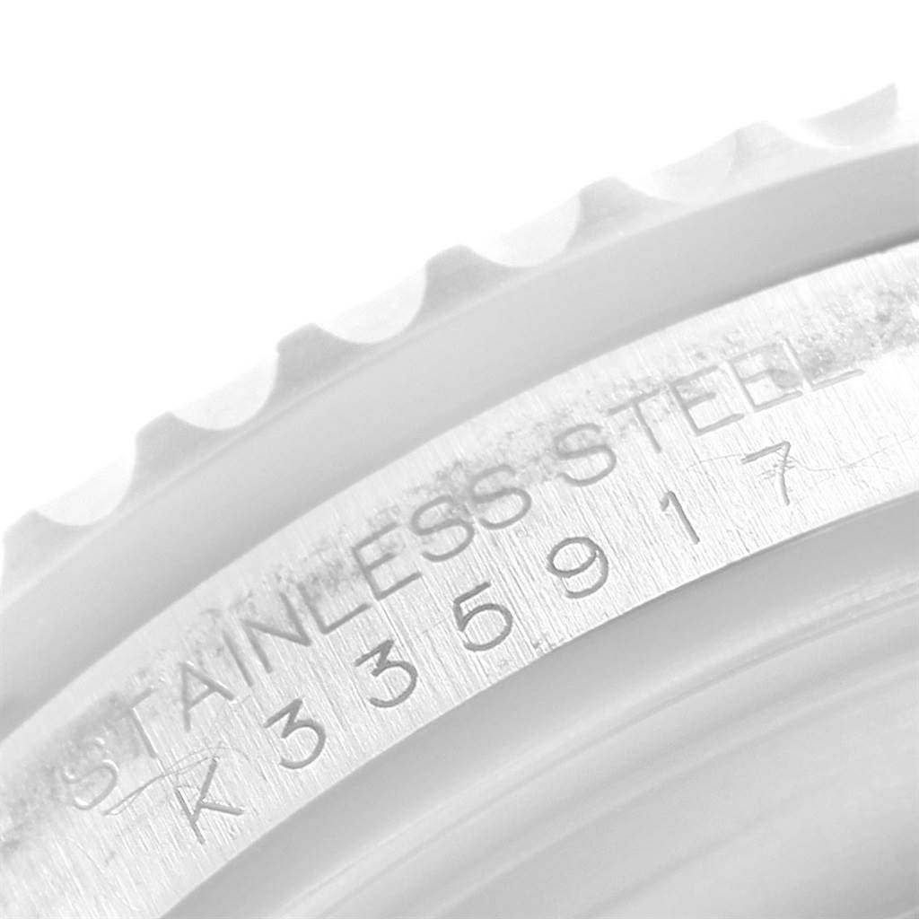 This close-up image shows the case side engraving and bezel edge of a Rolex Submariner 16610 Men's Stainless Steel Black Dial 16610 Men's Stainless Steel Black Dial watch.