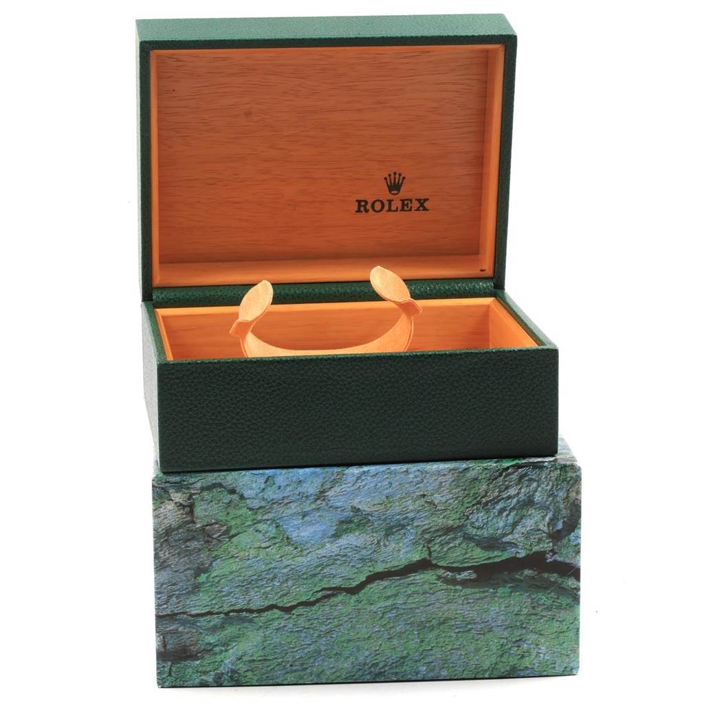 The image shows an empty Rolex Submariner 16610 Men's Stainless Steel Black Dial 16610 Men's Stainless Steel Black Dial watch box with its lid open, featuring green exterior and wooden interior.