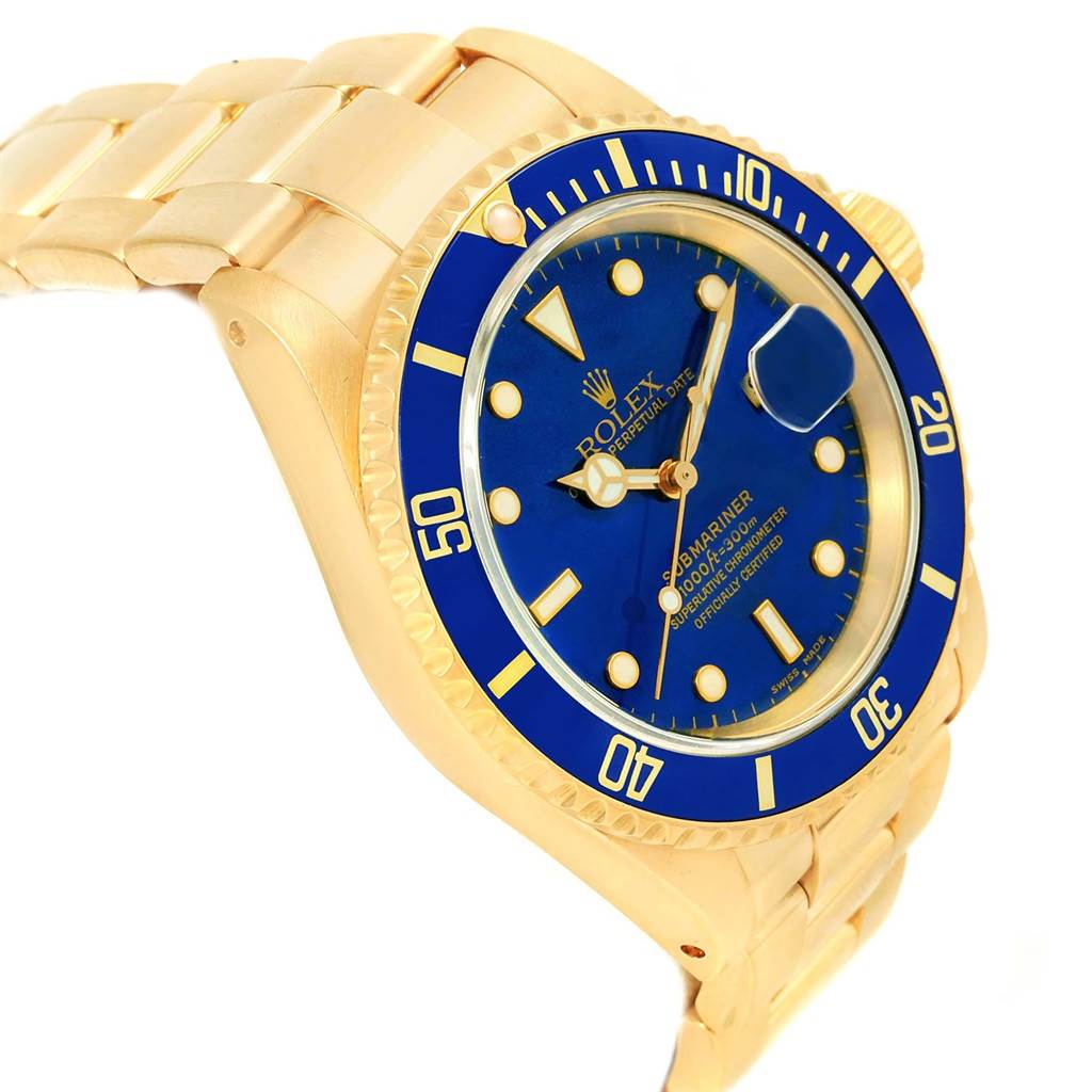 The Rolex Submariner 16618 Men's Yellow Gold Blue Dial 16618 Men's Yellow Gold Blue Dial watch is shown at an angle highlighting the blue dial, bezel, and a portion of the gold bracelet.