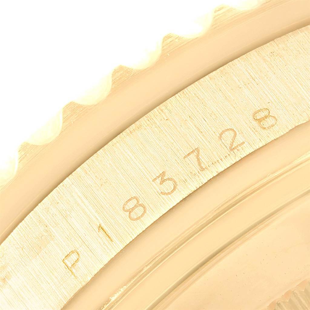 This image shows a close-up of the bezel and serial number engraving on a Rolex Submariner 16618 Men's Yellow Gold Blue Dial 16618 Men's Yellow Gold Blue Dial watch.