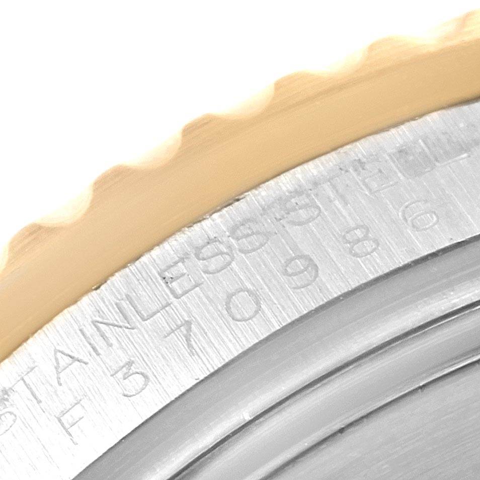 This close-up image of a Rolex Submariner 16613 Men's Steel and Gold (two tone) Blue Dial 16613 Men's Steel and Gold (two tone) Blue Dial watch shows the engraved text on the case and a portion of the bezel.