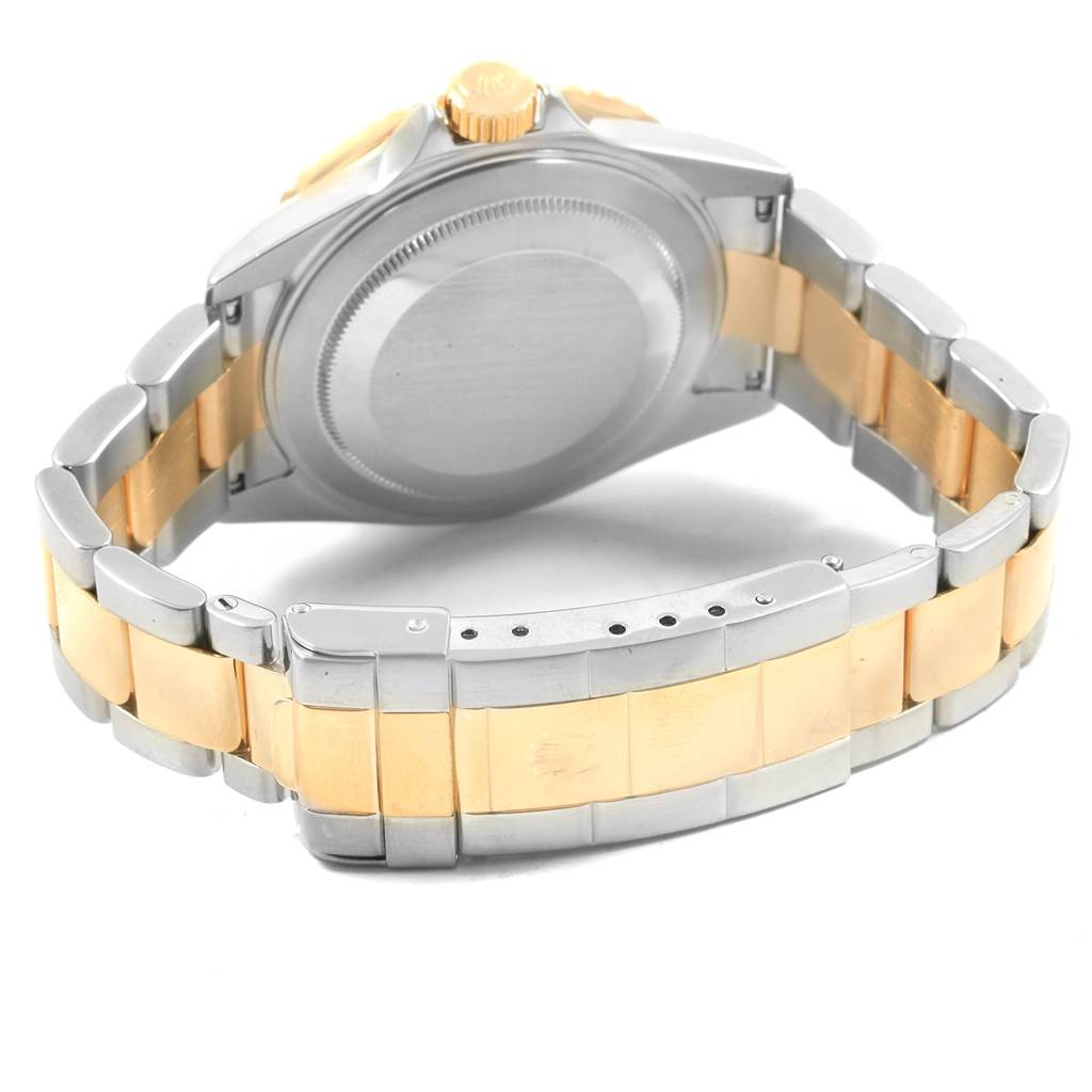 The image shows the back and bracelet of the Rolex Submariner 16613 Men's Steel and Gold (two tone) Blue Dial 16613 Men's Steel and Gold (two tone) Blue Dial watch, highlighting its two-tone metal in gold and silver.