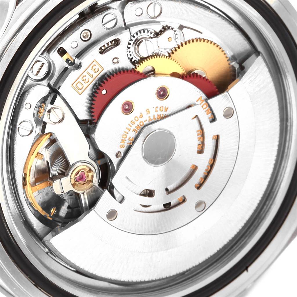 This image shows a close-up of the movement mechanism and gears inside a Rolex Submariner 14060 Men's Stainless Steel Black Dial 14060 Men's Stainless Steel Black Dial watch.