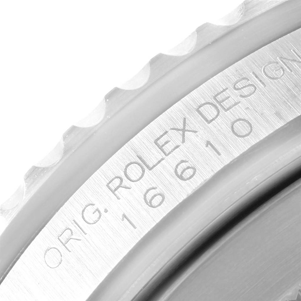 The image shows a close-up of the engraved text on the bezel edge of a Rolex Submariner 16610 Men's Stainless Steel Black Dial 16610 Men's Stainless Steel Black Dial watch.