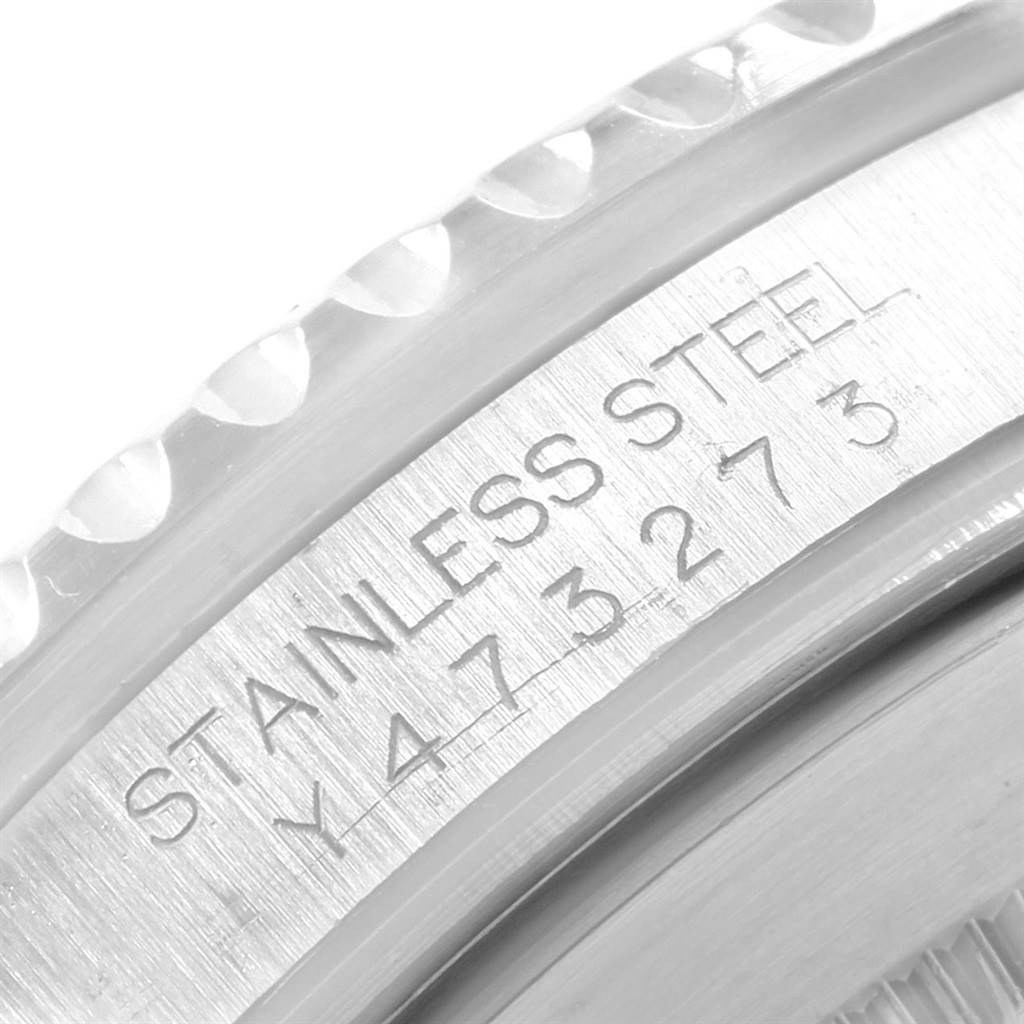 The image shows a close-up of the stainless steel engraving on the side of a Rolex Submariner 16610 Men's Stainless Steel Black Dial 16610 Men's Stainless Steel Black Dial watch case.